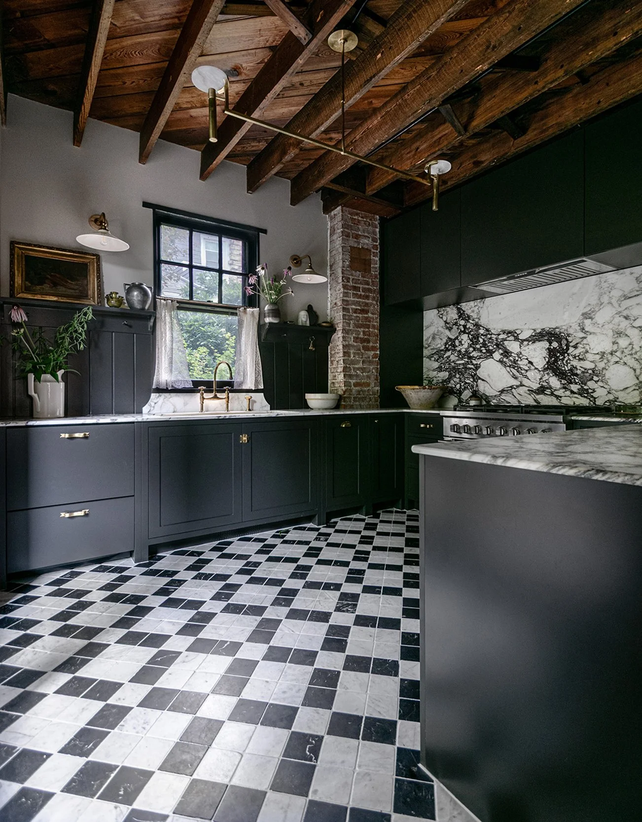 Historic Hyde Park Kansas City kitchen remodel with moody black cabinetry, marble backsplash, and custom lighting by Erica Kay Design & Remodeling