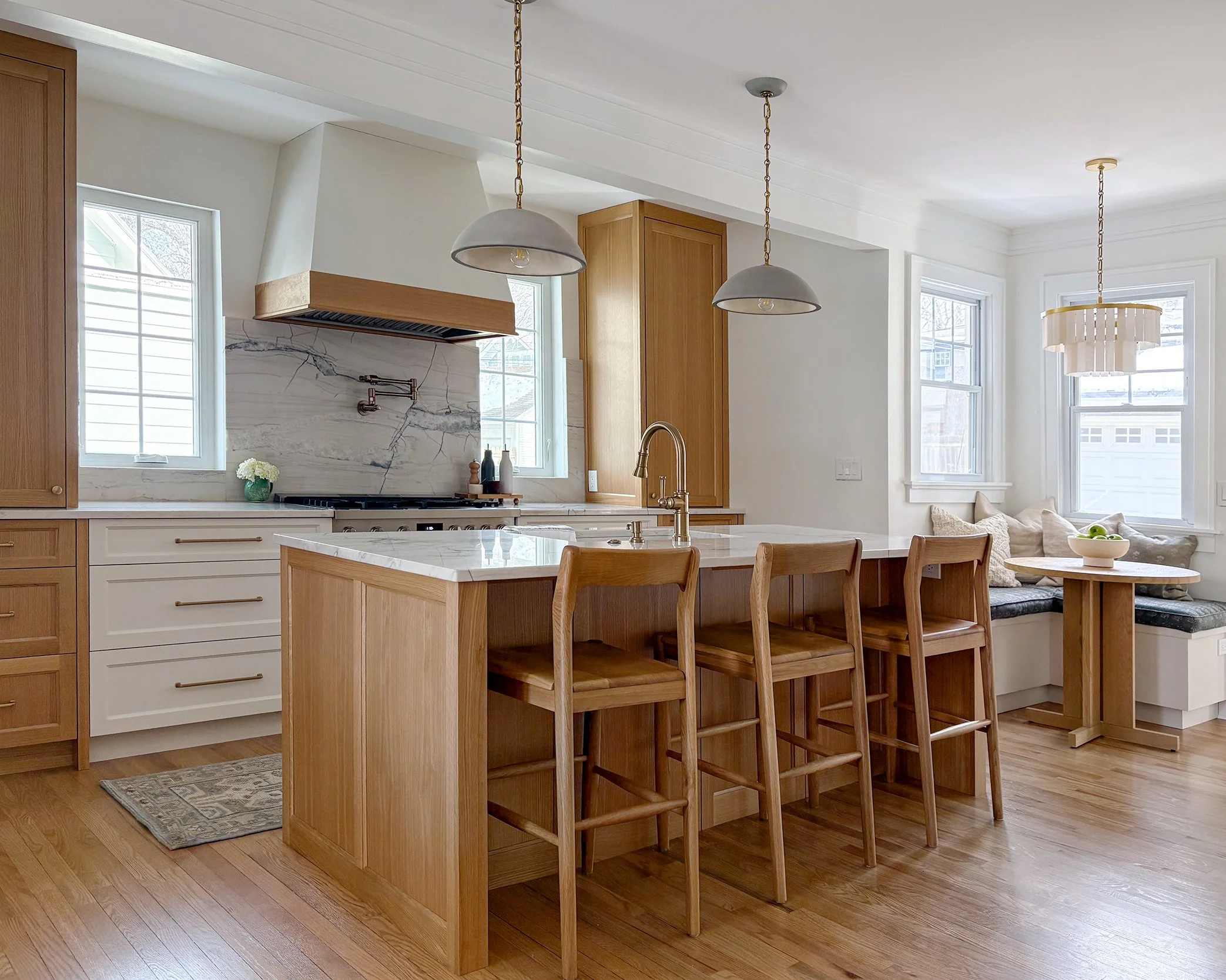 Kansas City kitchen remodel featuring white oak cabinetry, warm whites, and timeless brass accents by Erica Kay Design.