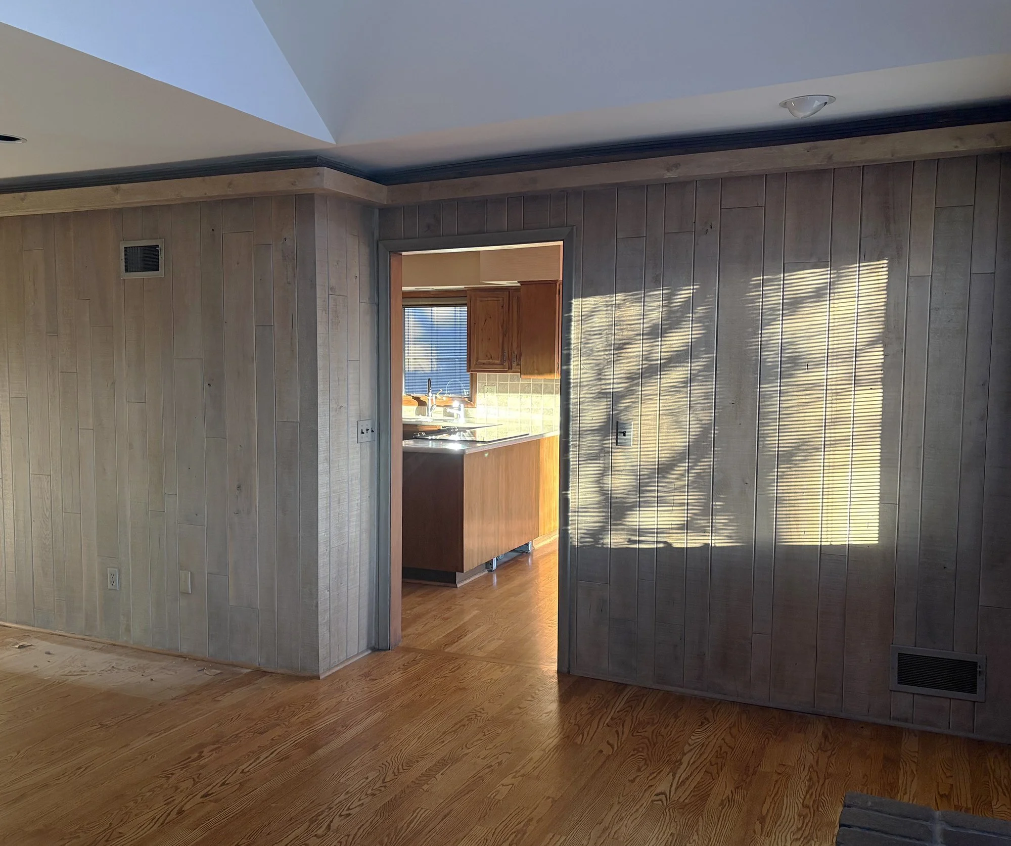 Wall and narrow doorway separating the living room from the kitchen before the Prairie Village renovation.