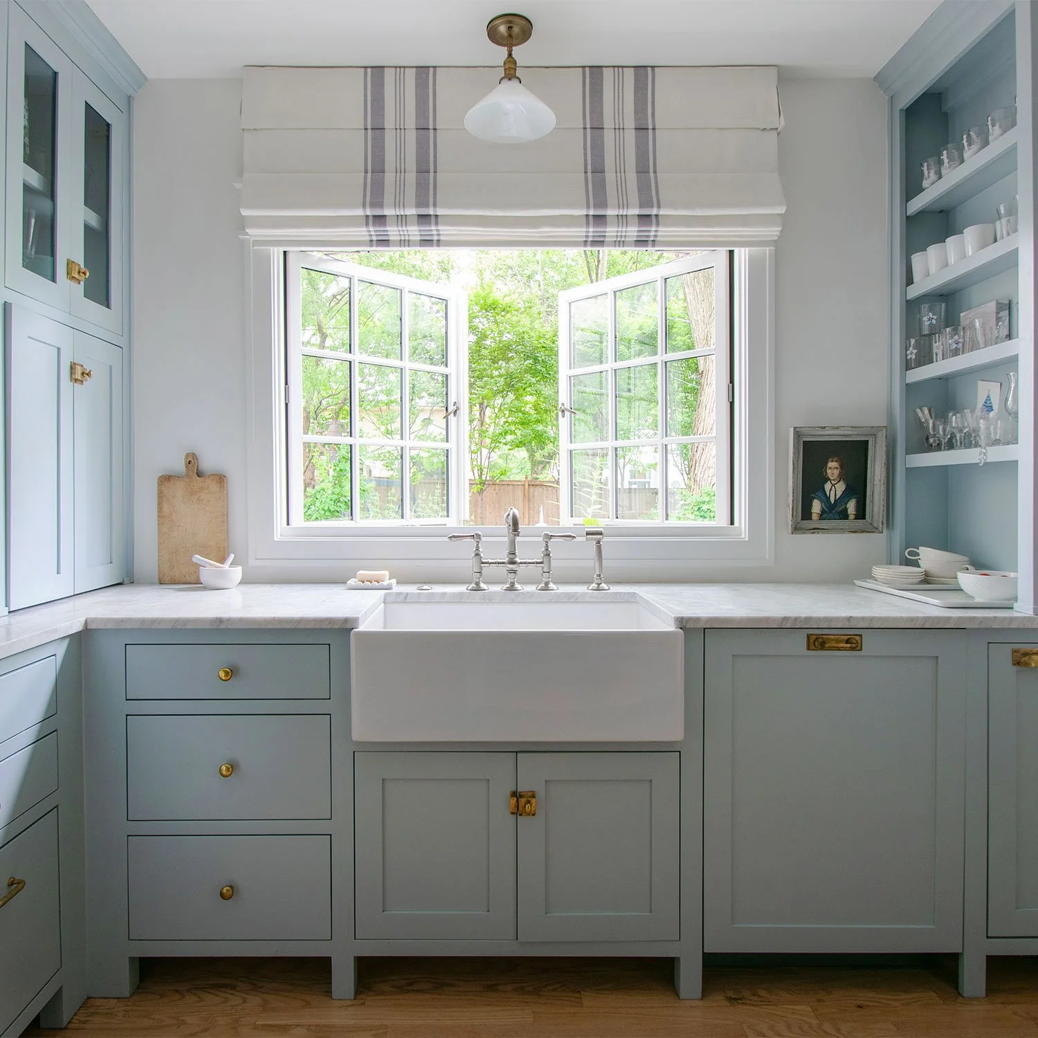Custom kitchen finish selections featuring nickel faucet, stone countertops, and inset cabinetry by Erica Kay Design in Fairway, Kansas City