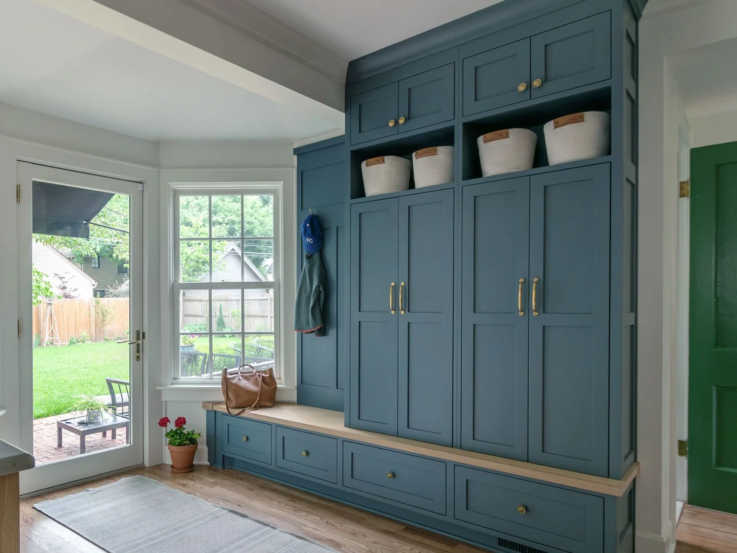 Mudroom cabinetry painted in Sherwin-Williams Slate Tile, with a white oak bench, drawers, and open storage cubbies.