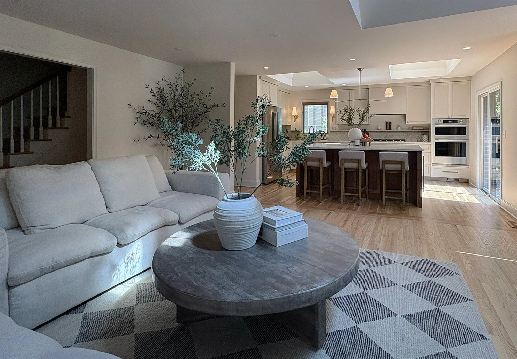 Remodeled Prairie Village kitchen with painted cabinetry, a walnut island, Taj Mahal countertops, and two large skylights.