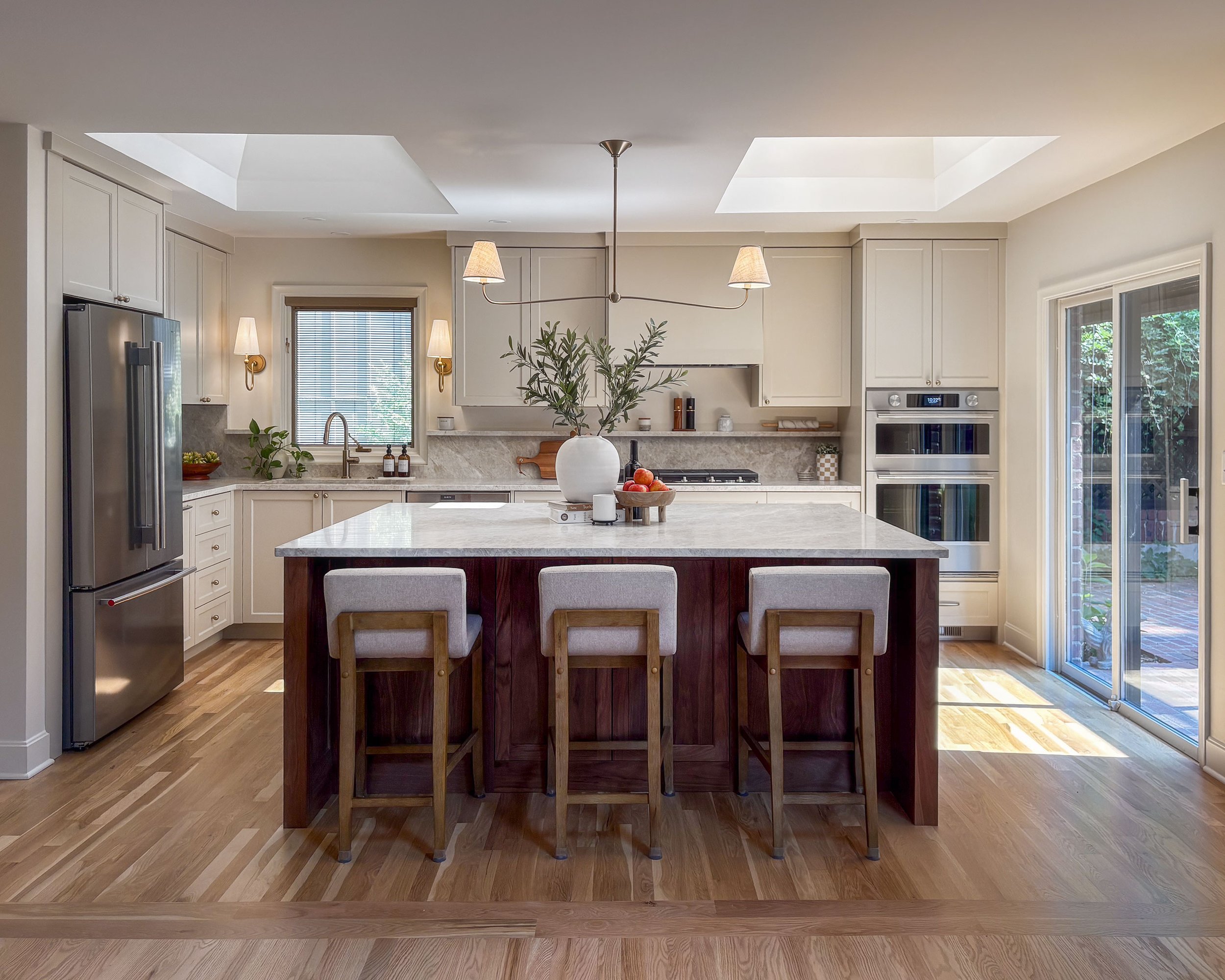 Prairie Village classic kitchen, featuring a walnut island, quartzite countertops and backsplash, and thoughtful lighting.