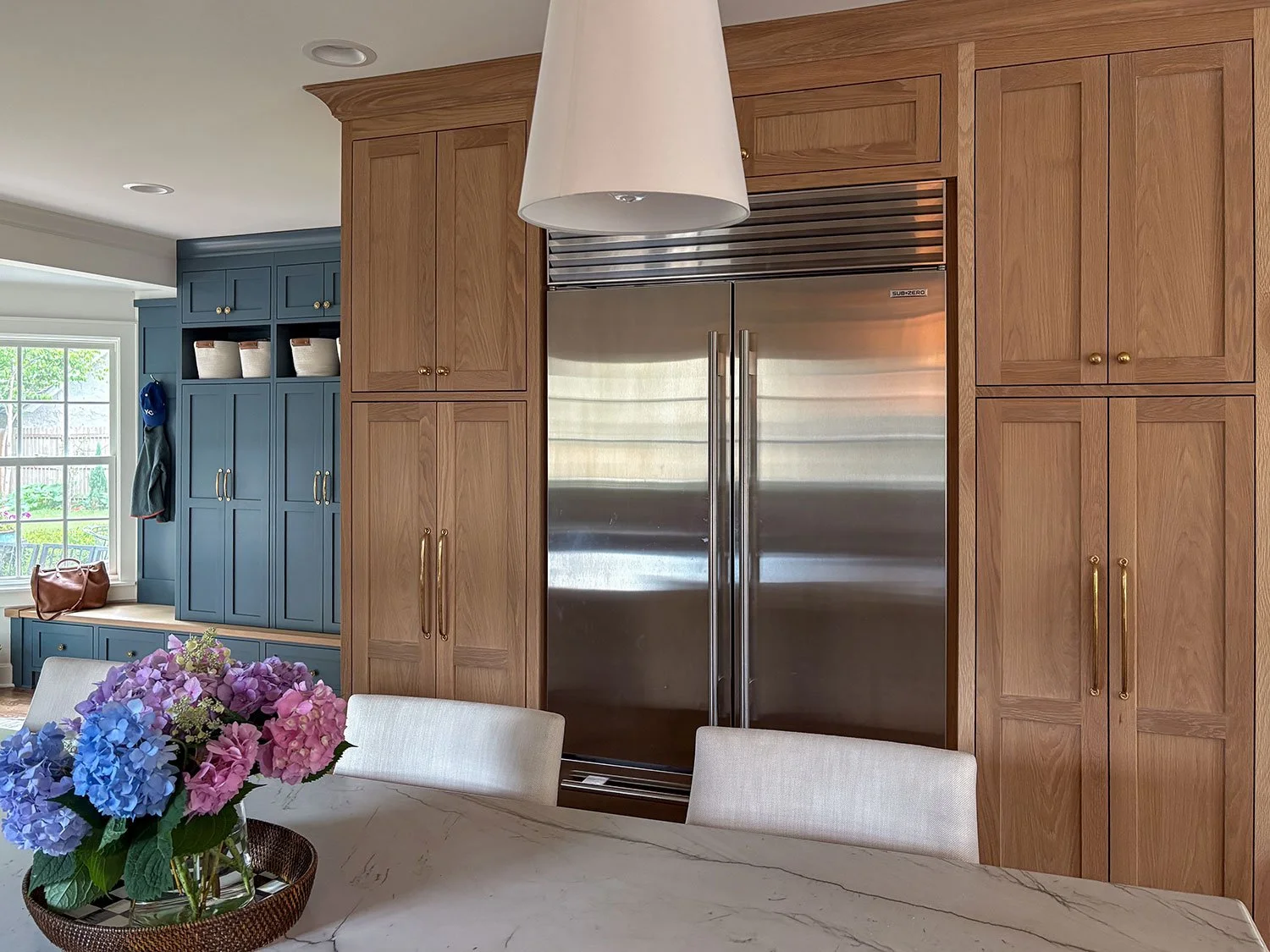 Mudroom cabinetry painted in Sherwin-Williams Slate Tile, with a white oak bench, drawers, and open storage cubbies.