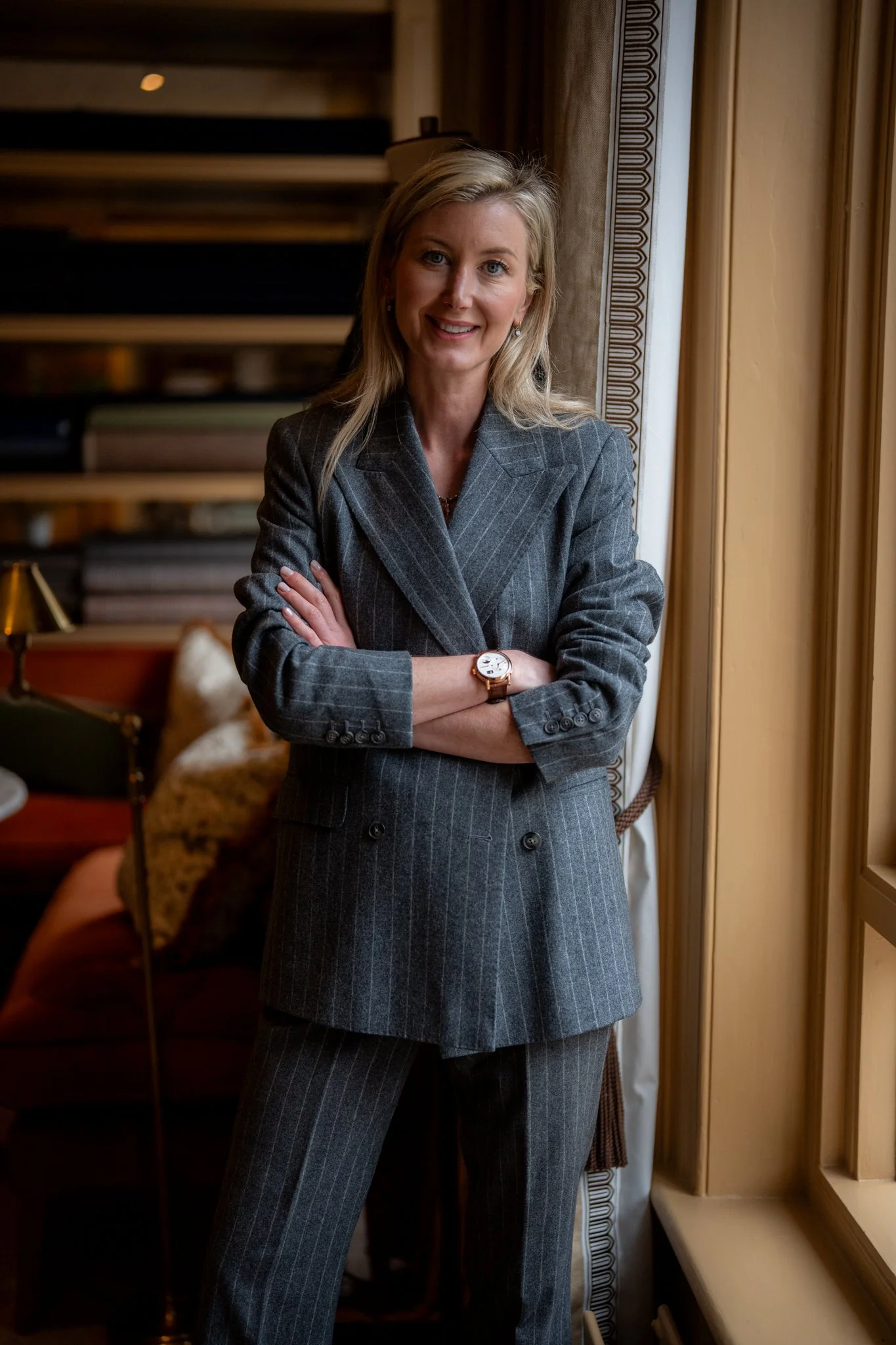 Caroline Andrew Profile Picture wearing flannel grey pinstripe suit of her own design.=