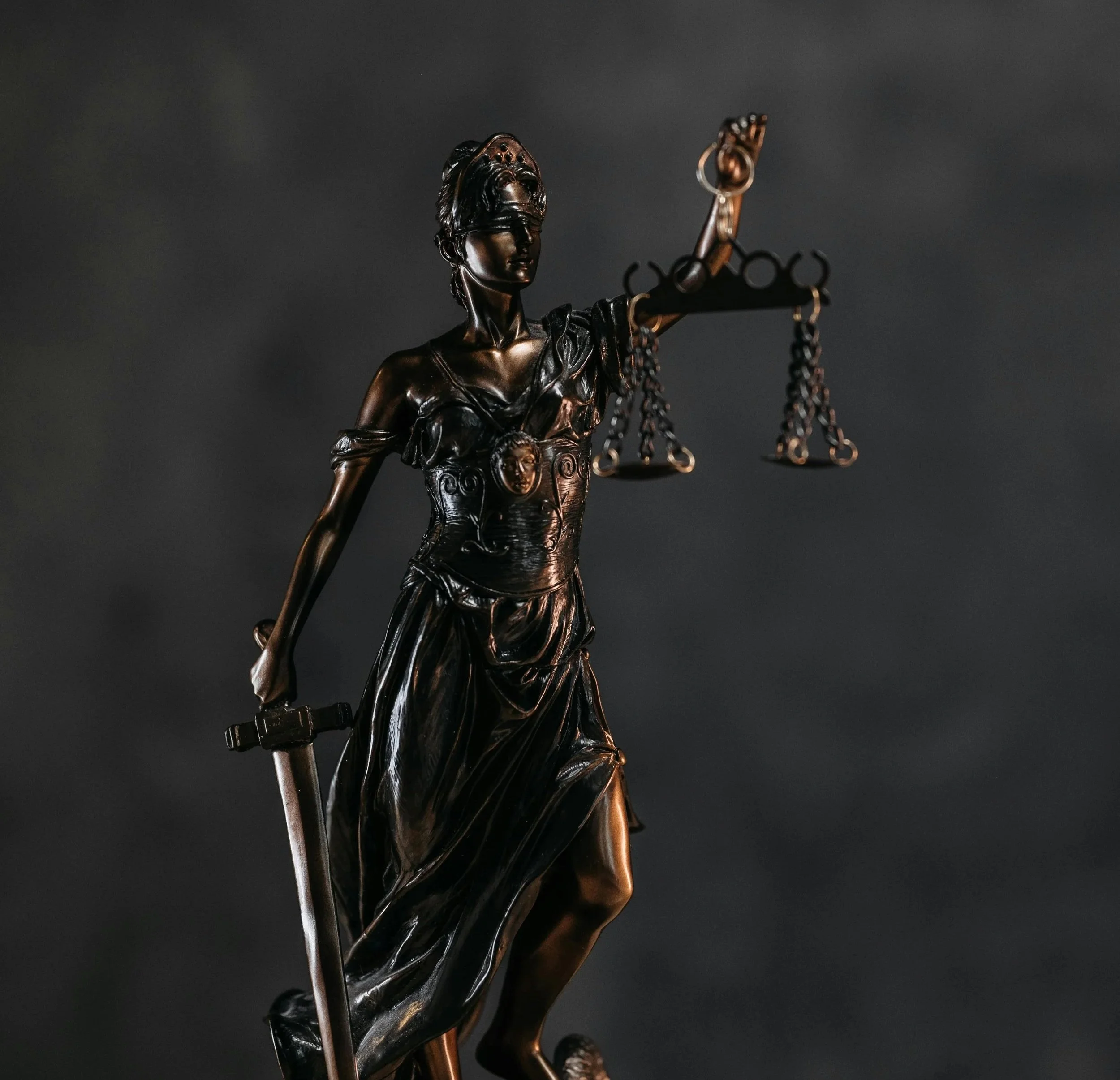 Statue of Lady Justice holding a sword in one hand and scales in the other.