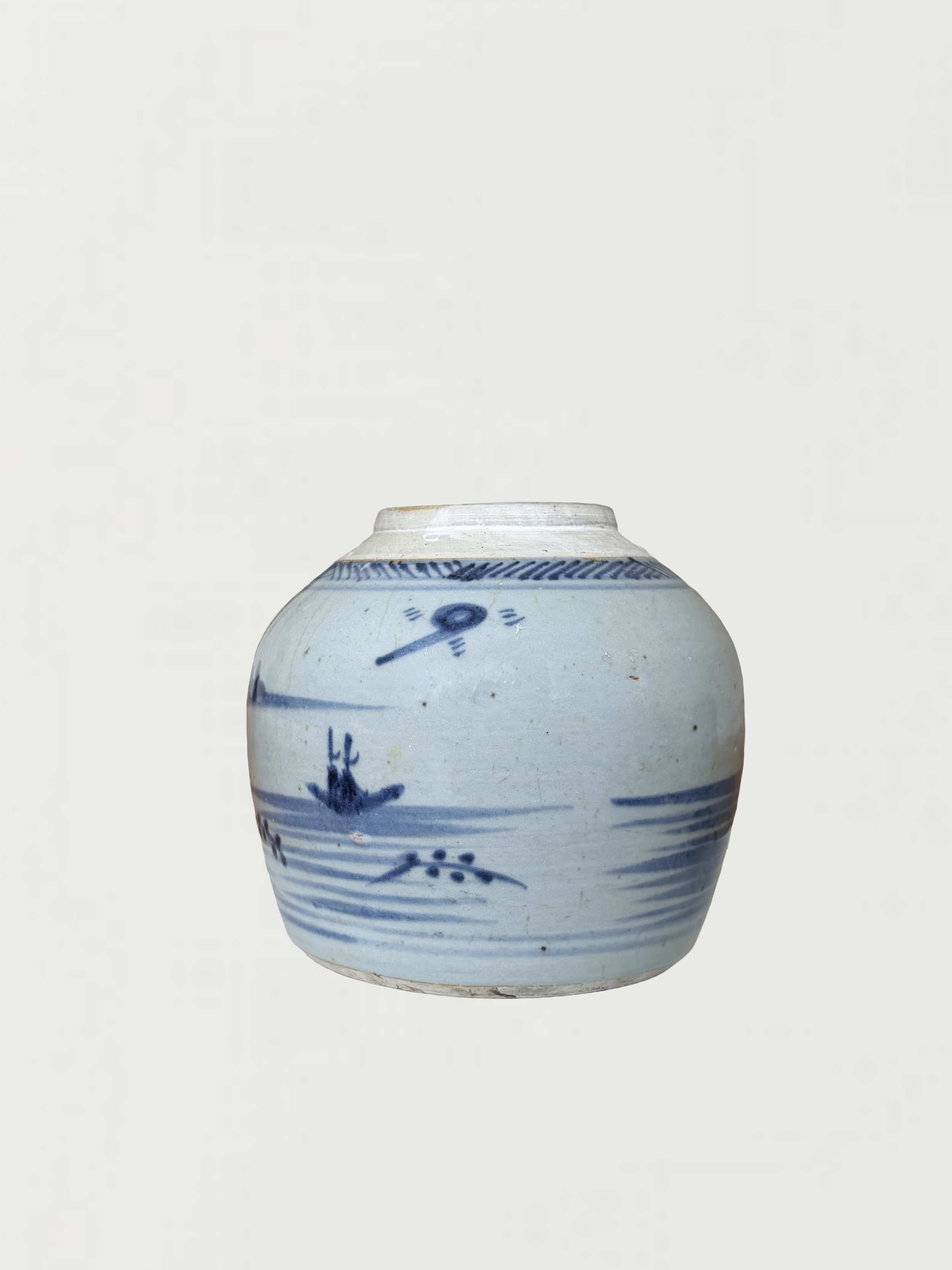 A white ceramic vase decorated with blue painted illustrations of boats, water, and plants, with a narrow mouth and rounded body.