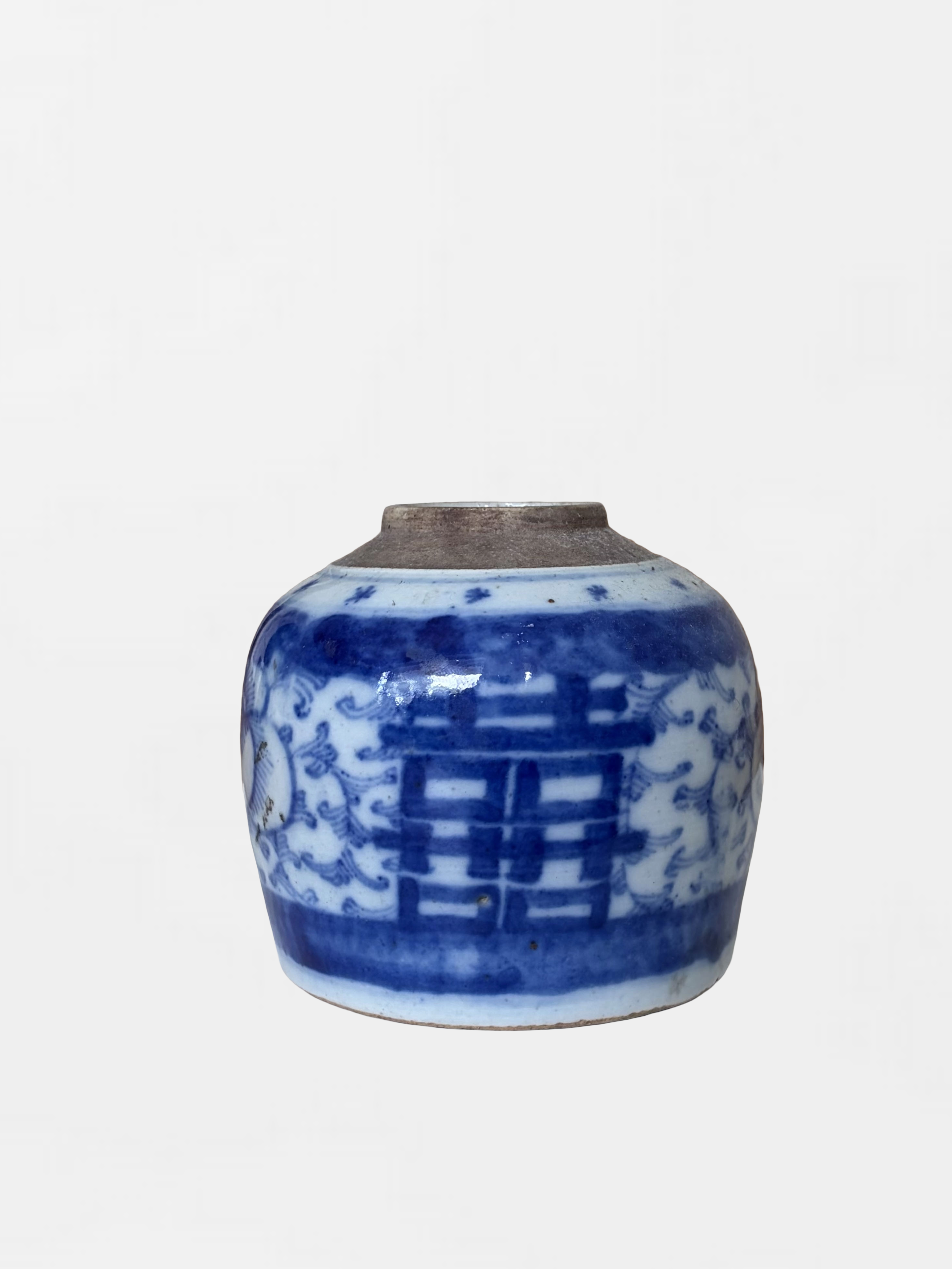 Blue and white porcelain vase with intricate designs, top rim slightly chipped.