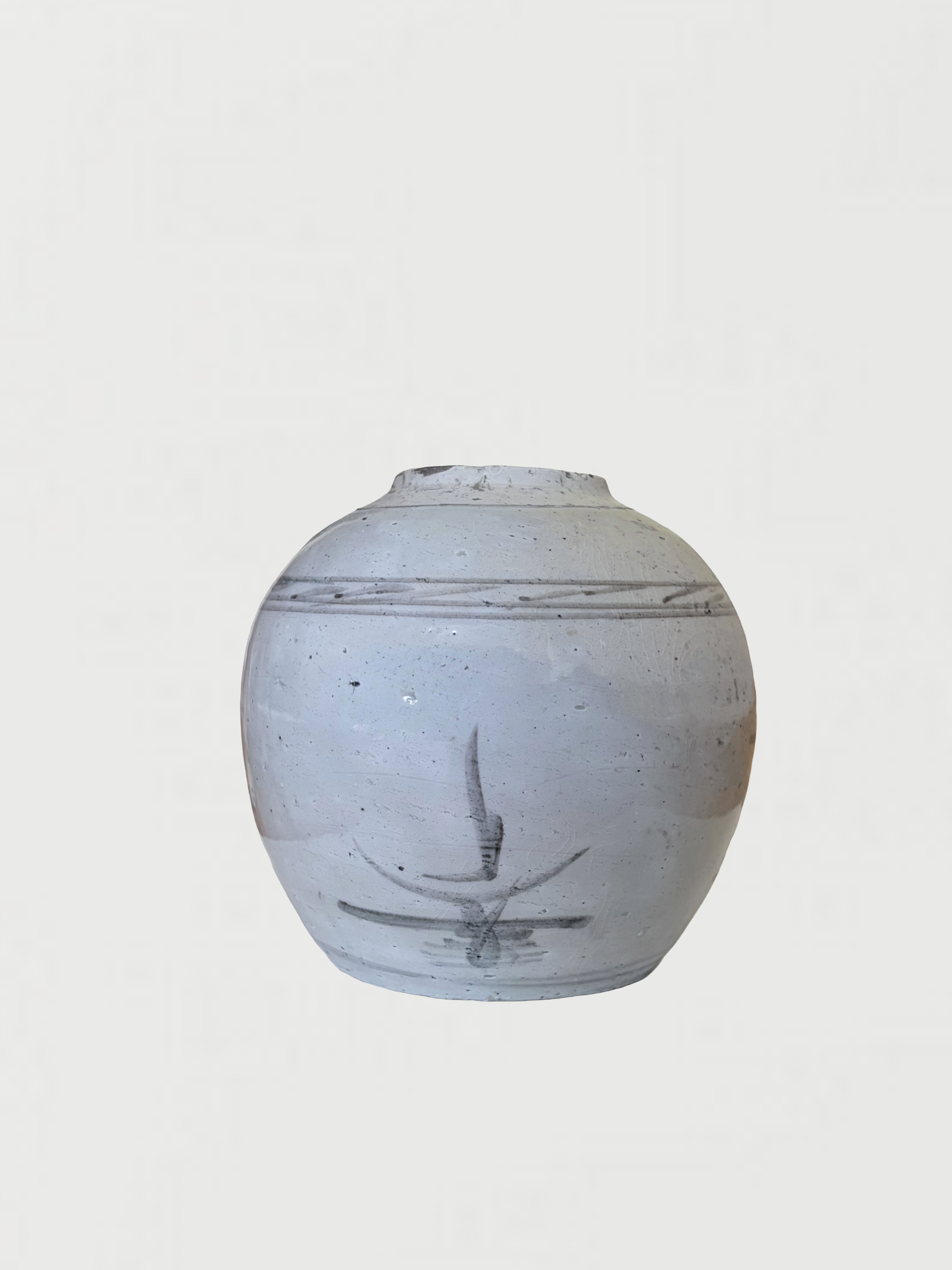 White ceramic vase with black and gray streaks and circular patterns, placed against a plain light background.