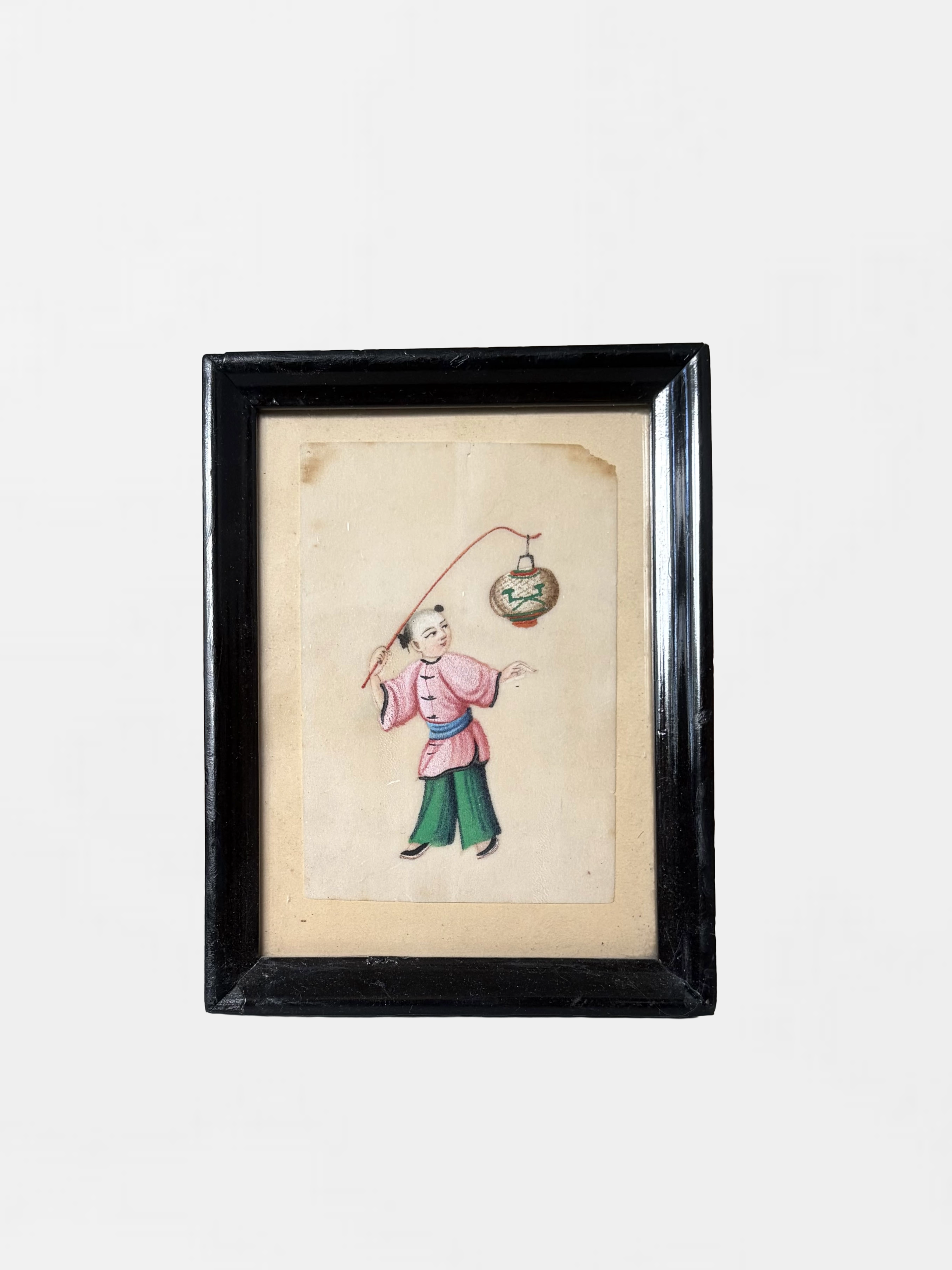 Framed traditional Asian artwork depicting a person holding a fishing rod with a lantern hanging above.