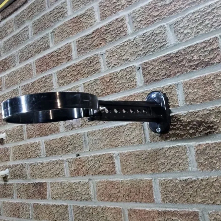 PVC pipe clip and bracket mounted on brick wall