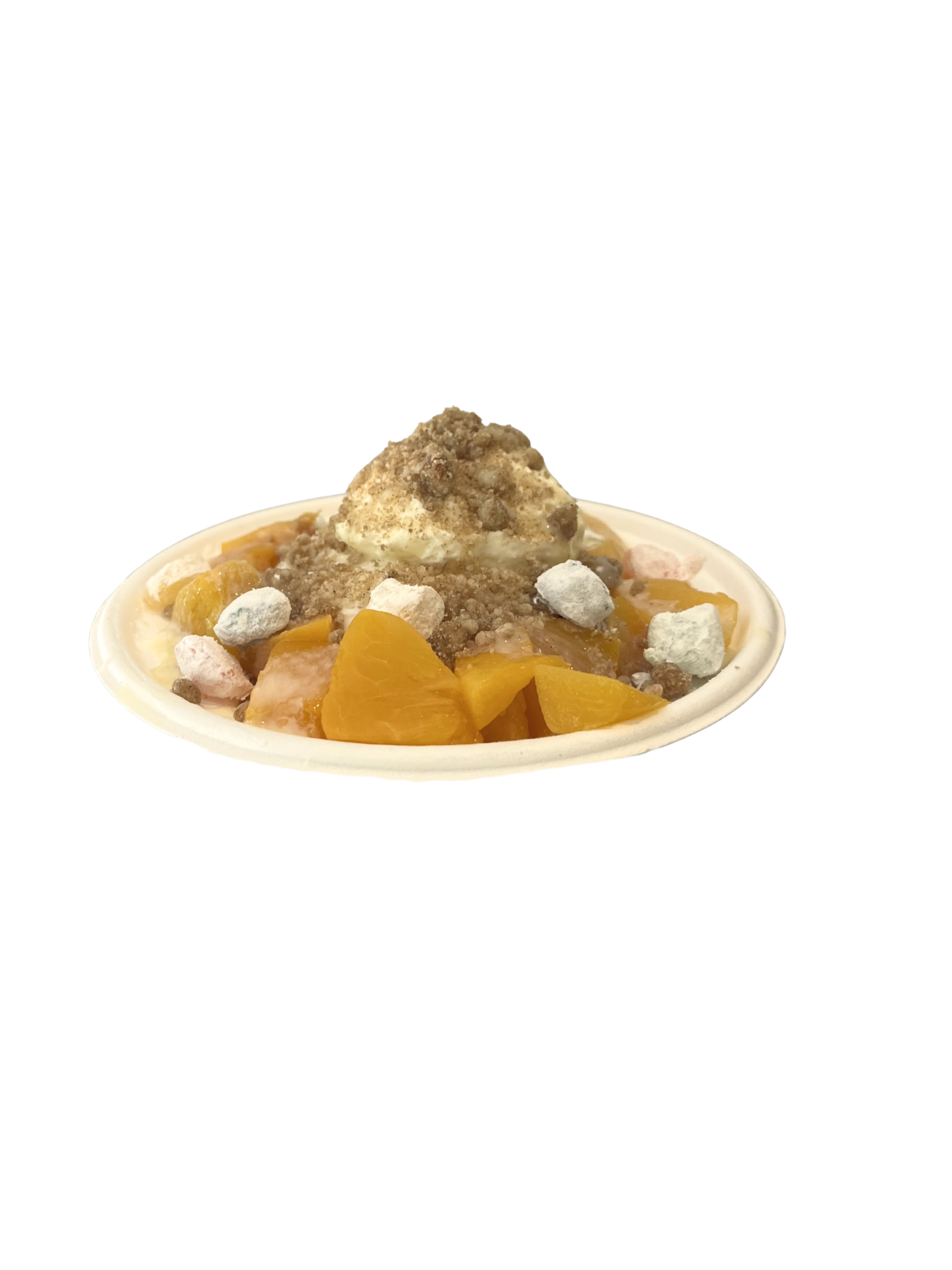 A bowl of peach cobbler topped with whipped cream, crushed cookies, and a crumbly streusel, with chunks of peaches underneath.