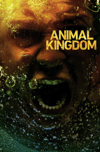 A person underwater with an open mouth, with bubbles around and the text 'Animal Kingdom' in yellow.