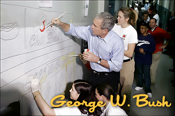 A man in a light blue shirt and glasses is painting on a whiteboard while a group of students observe. The scene is in a school hallway.