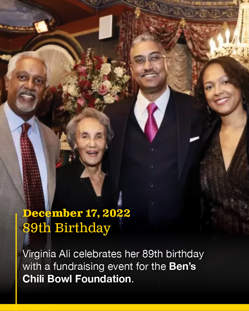 Group of four people standing together in a decorated room, celebrating Virginia Ali's 89th birthday with a fundraising event for the Ben's Chili Bowl Foundation on December 17, 2022.