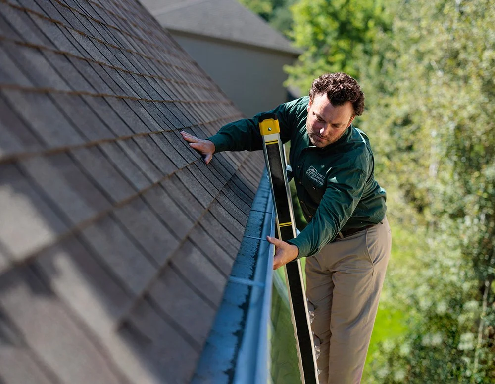 npi-inspector-on-ladder-checking-gutters.jpg