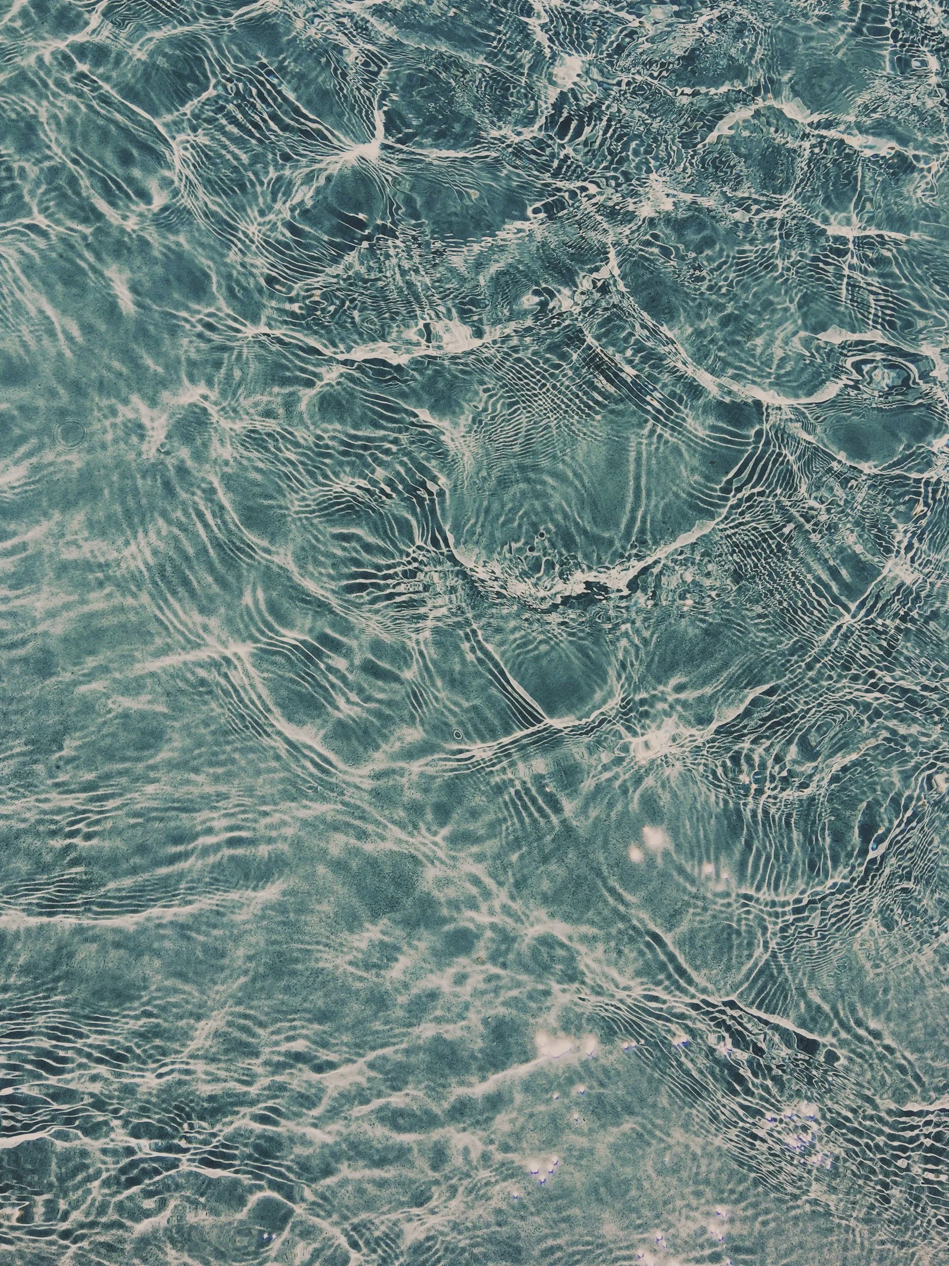 Close-up of turquoise / blue waters and ripples in the waves.