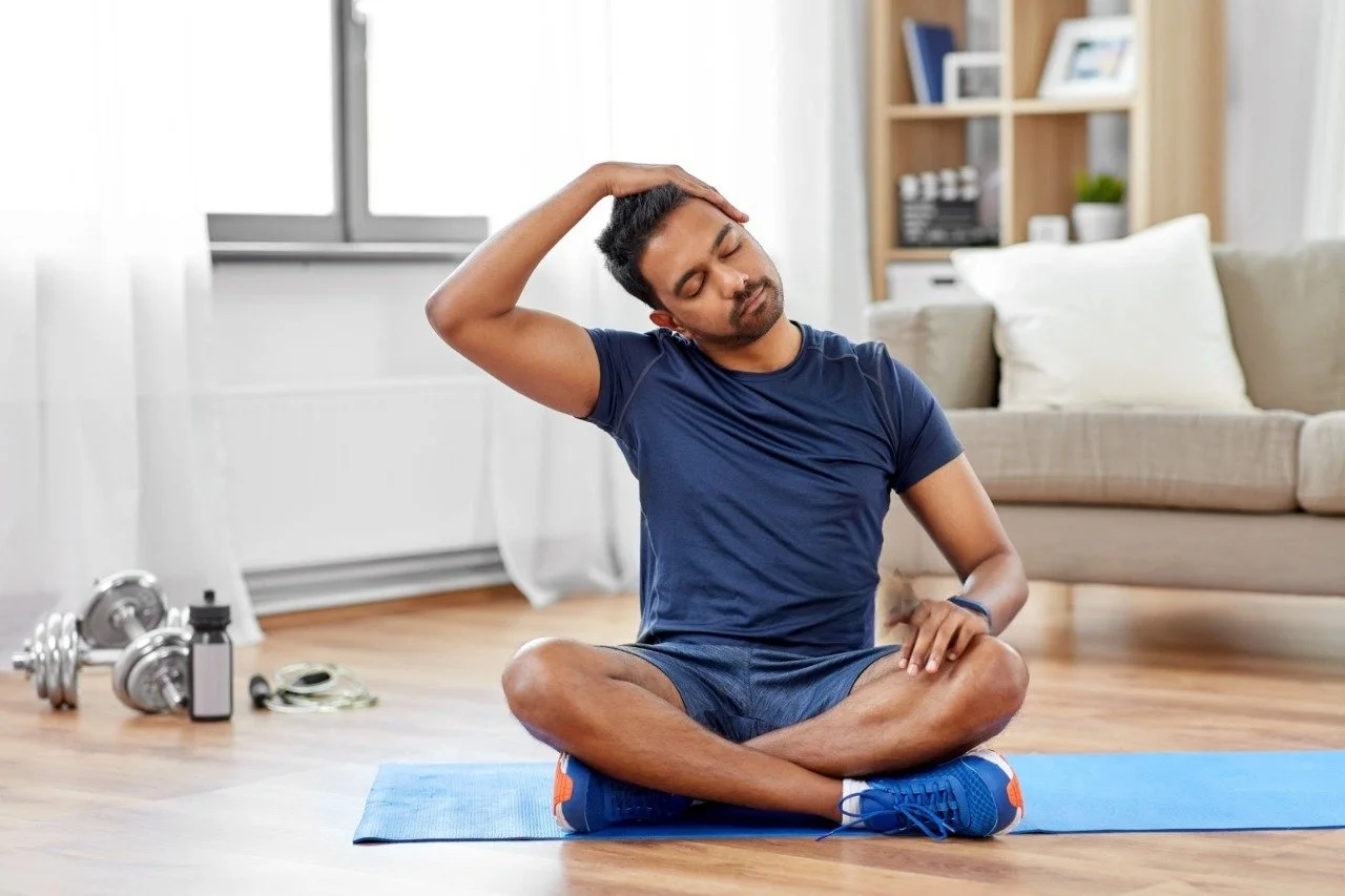 Man training and stretching neck at home