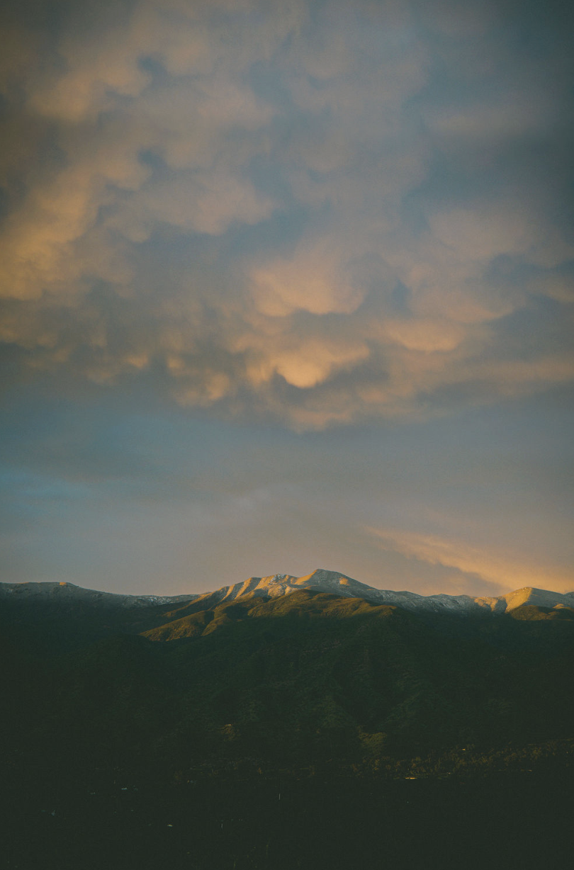 Sunlit view of Chief's Peak under a partly cloudy sky at sunset.