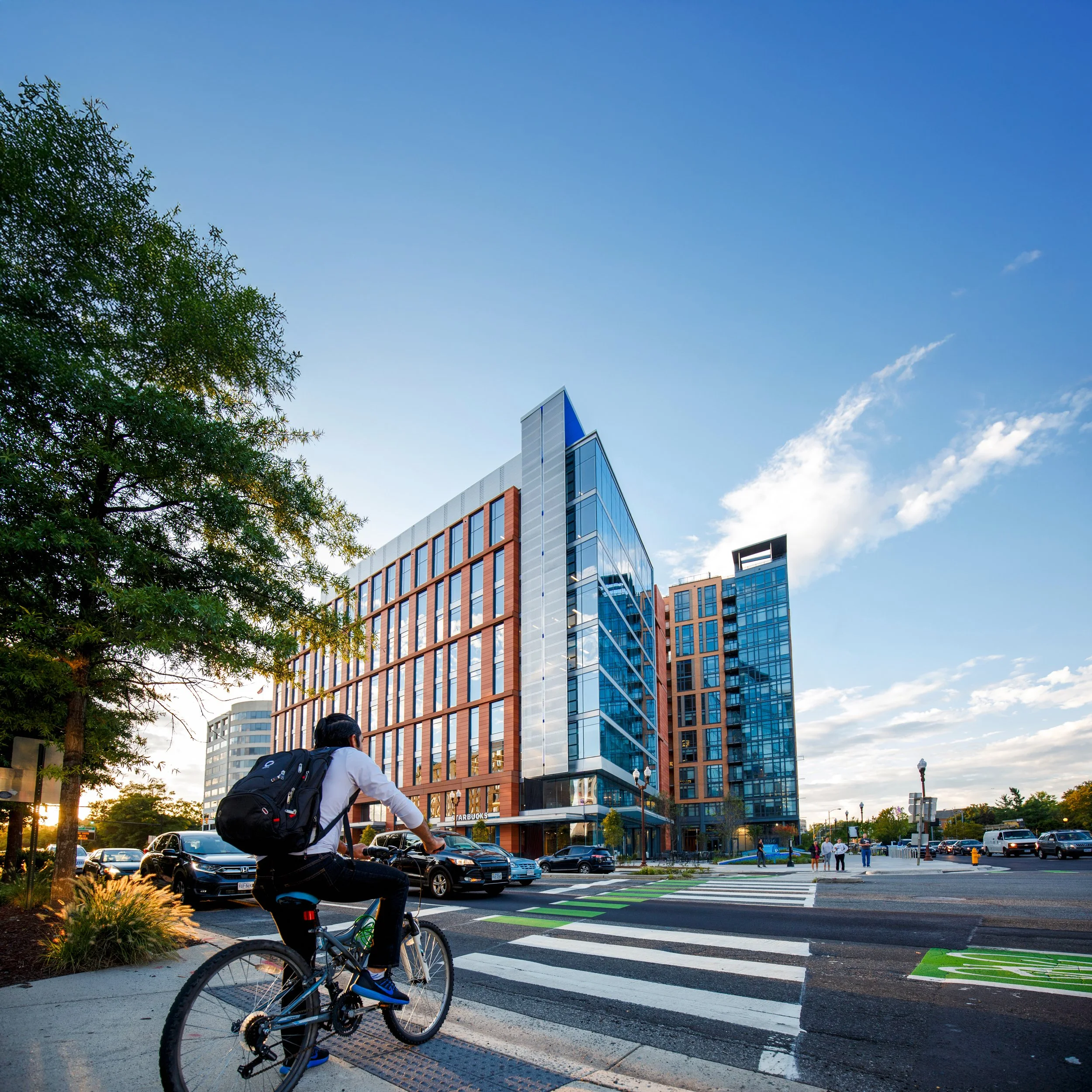Student on a bicycle riding toward the Marymount Ballston Center