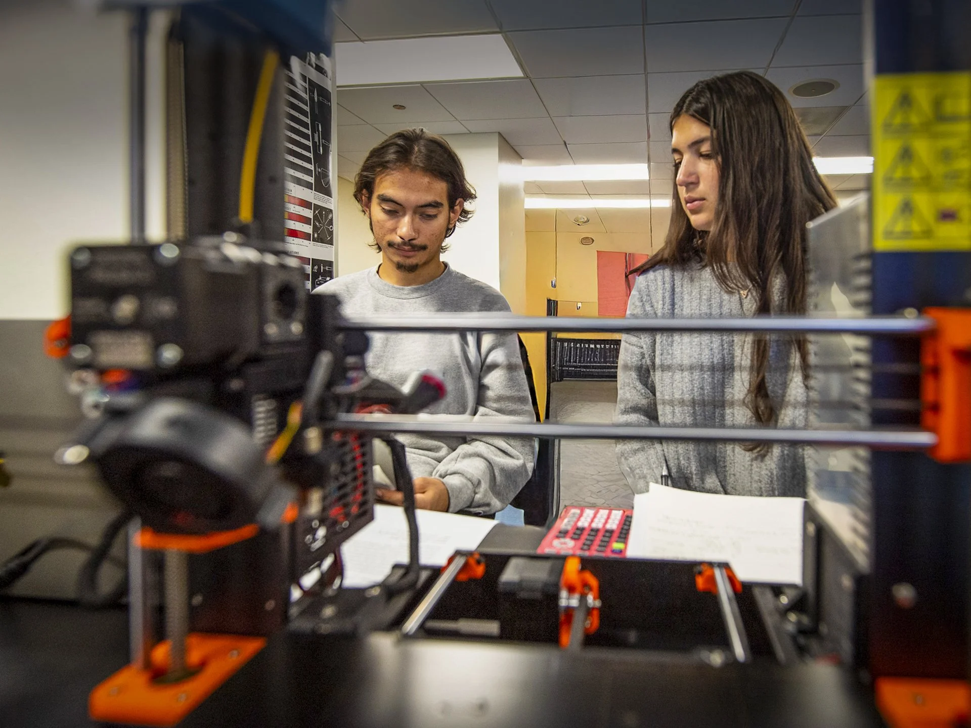 Students in a classroom working on with a 3d printer