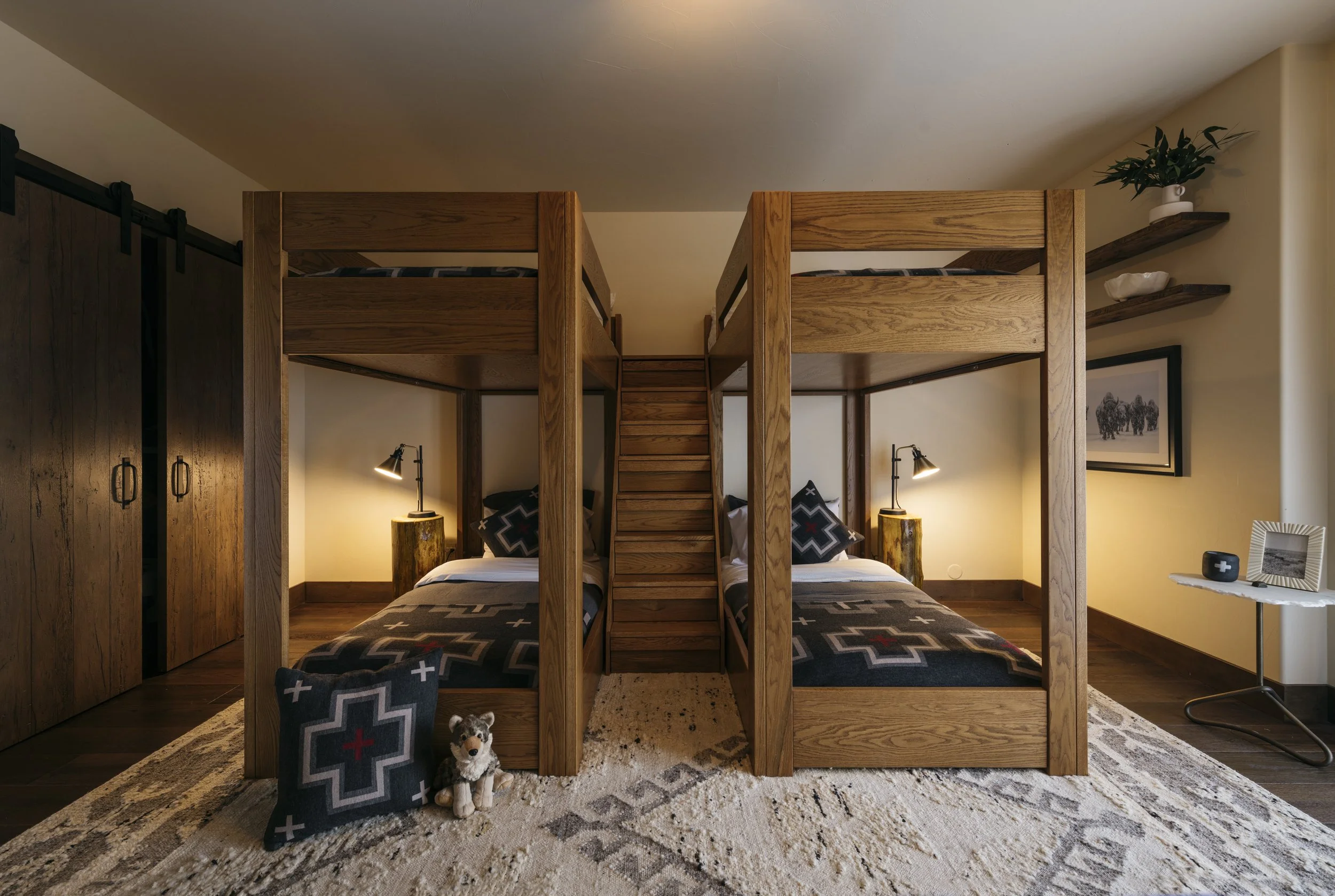ICON Bunks - a pair of two solid wood bunk beds with stairs in between. Each stair is a storage drawer. 
