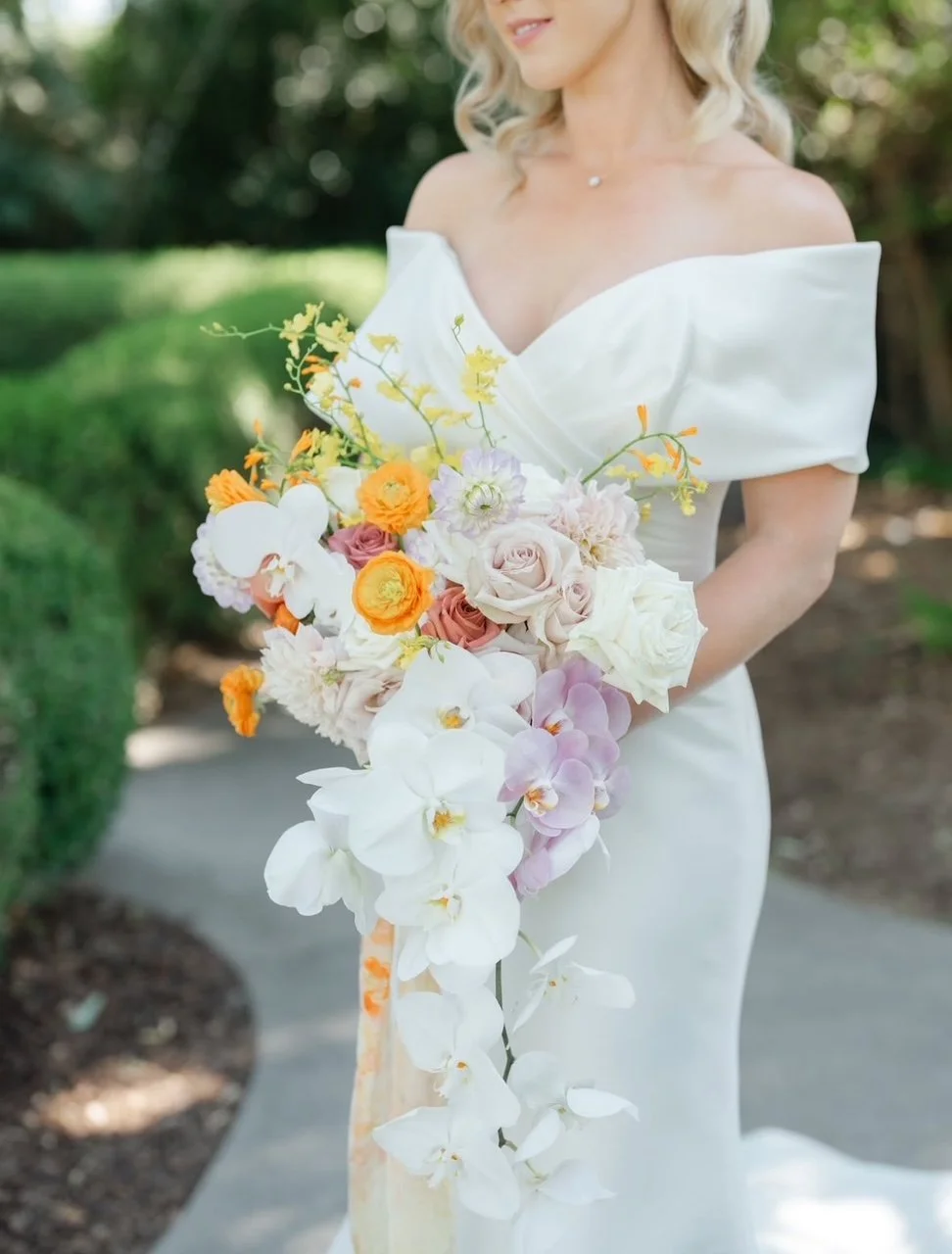 The Blonde Bouquet Floral Design - Northern California. Florist for Napa, Lake Tahoe, San Francisco, Sonoma weddings. Cascading orchid asymmetrical bridal bouquet. Orchid, pale purple, yellow, and white color palette.