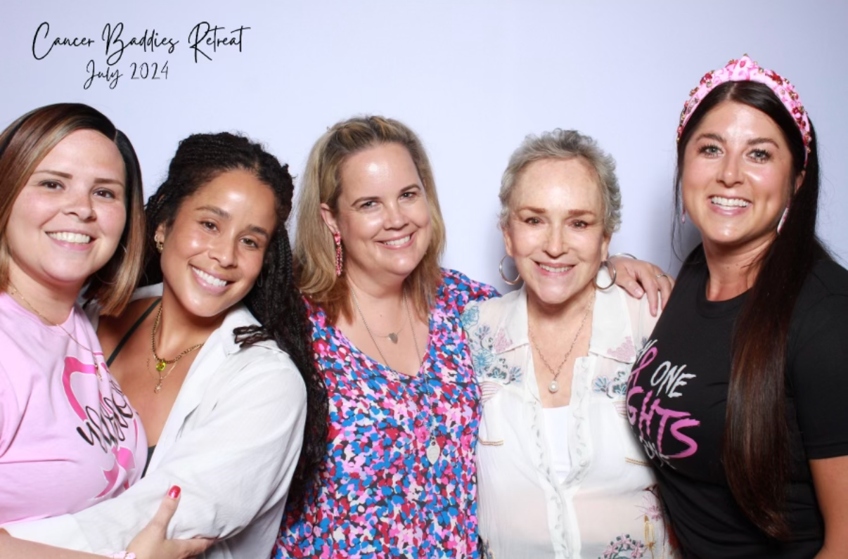 Group of five women smiling and posing together at a cancer awareness retreat in July 2024.