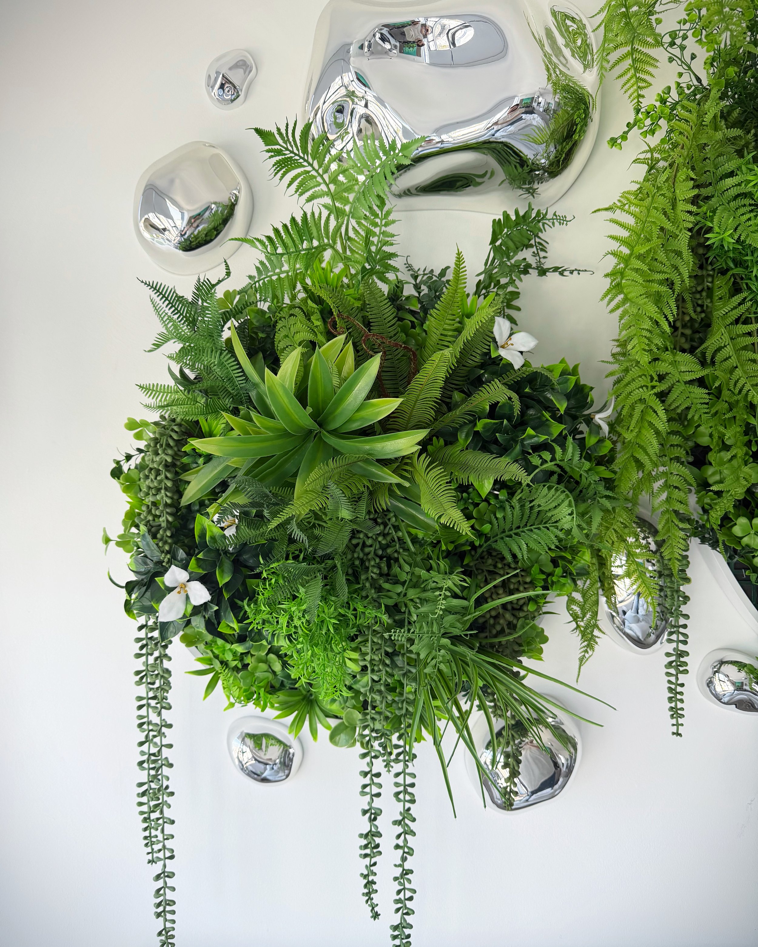 Circular custom-made botanical wall art featuring lush green tropical plants.