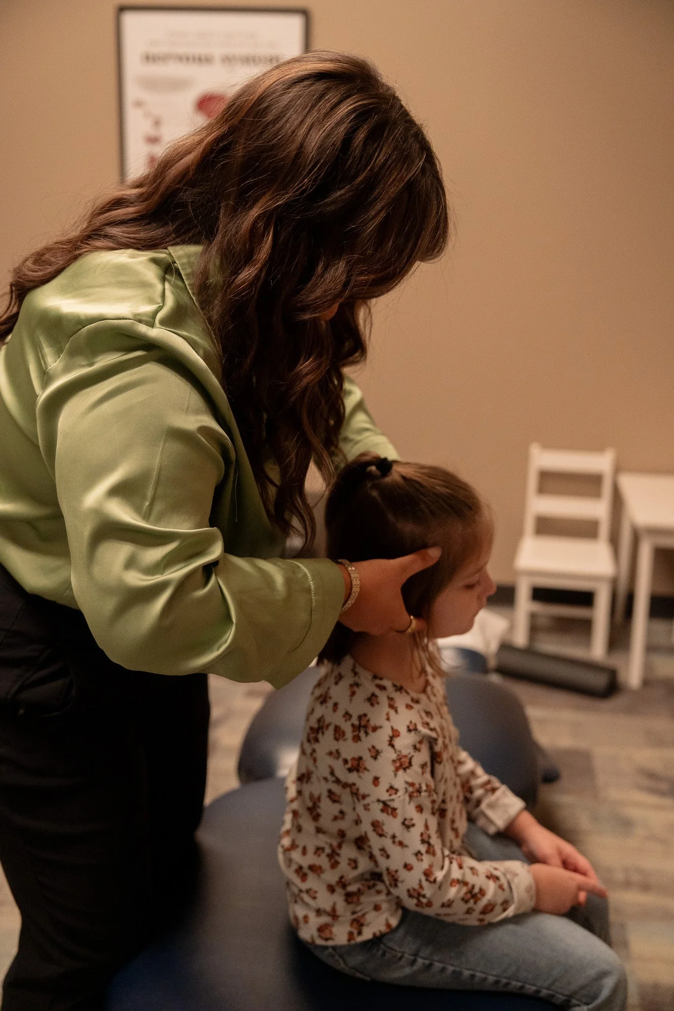 Dr. Sophia Duarte performing a gentle chiropractic adjustment on a young child at Radiant Chiropractic in West Ashley, Charleston SC
