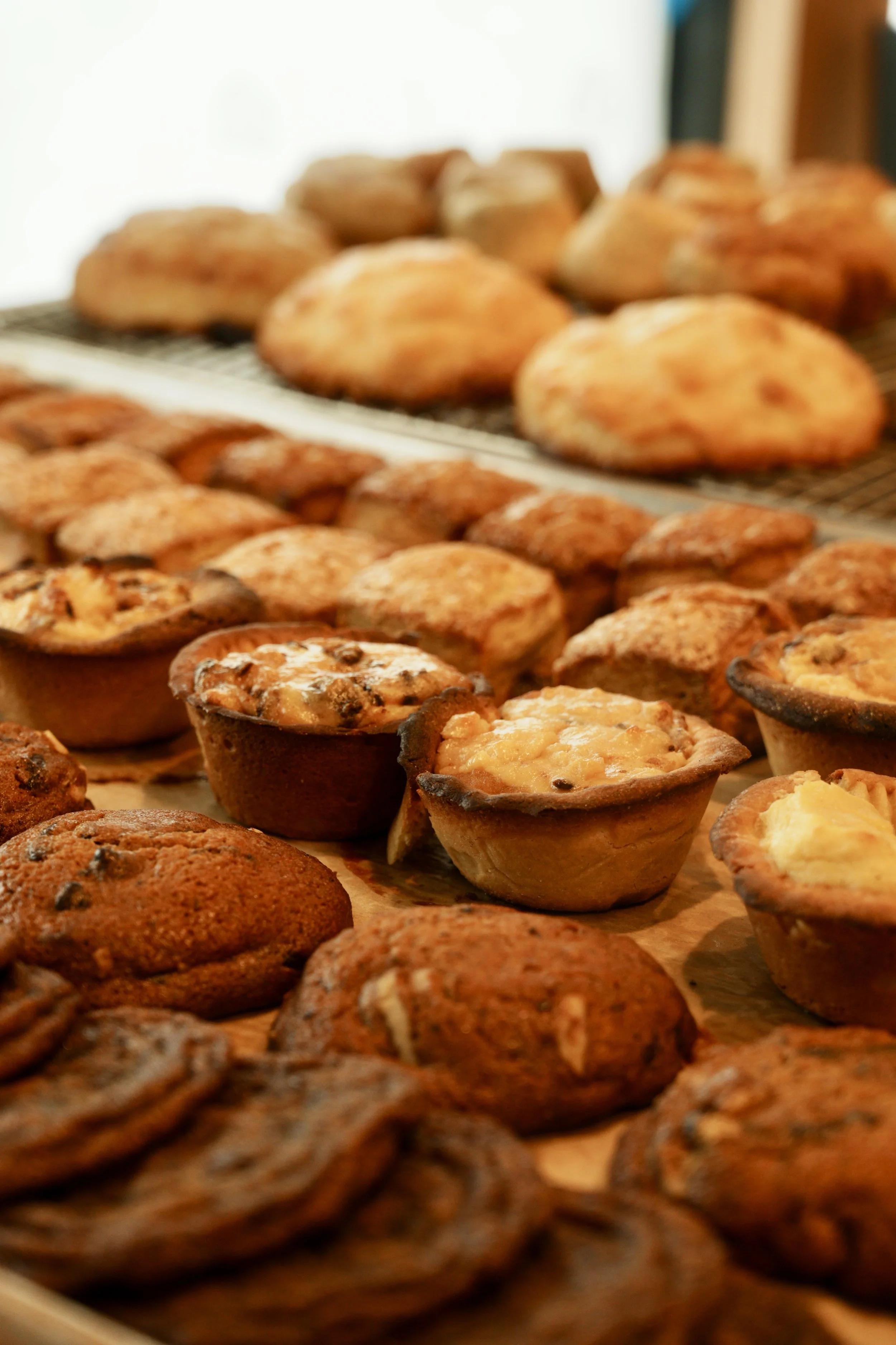 Assorted muffins and cookies on a baking sheet.