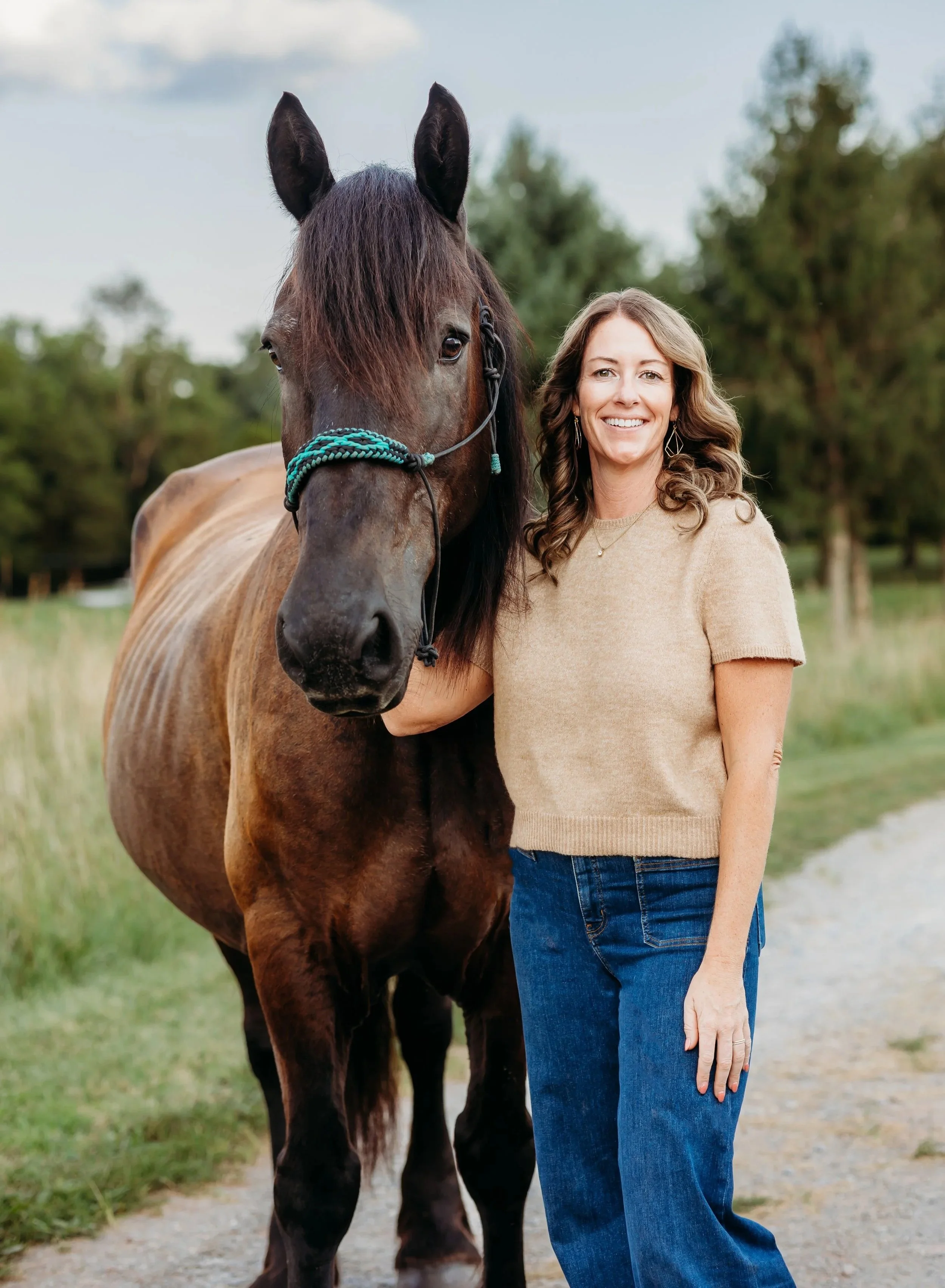 Karena Hammon, the Mindful Nurse Practitioner standing with a beautiful brown horse for equine-assisted learning