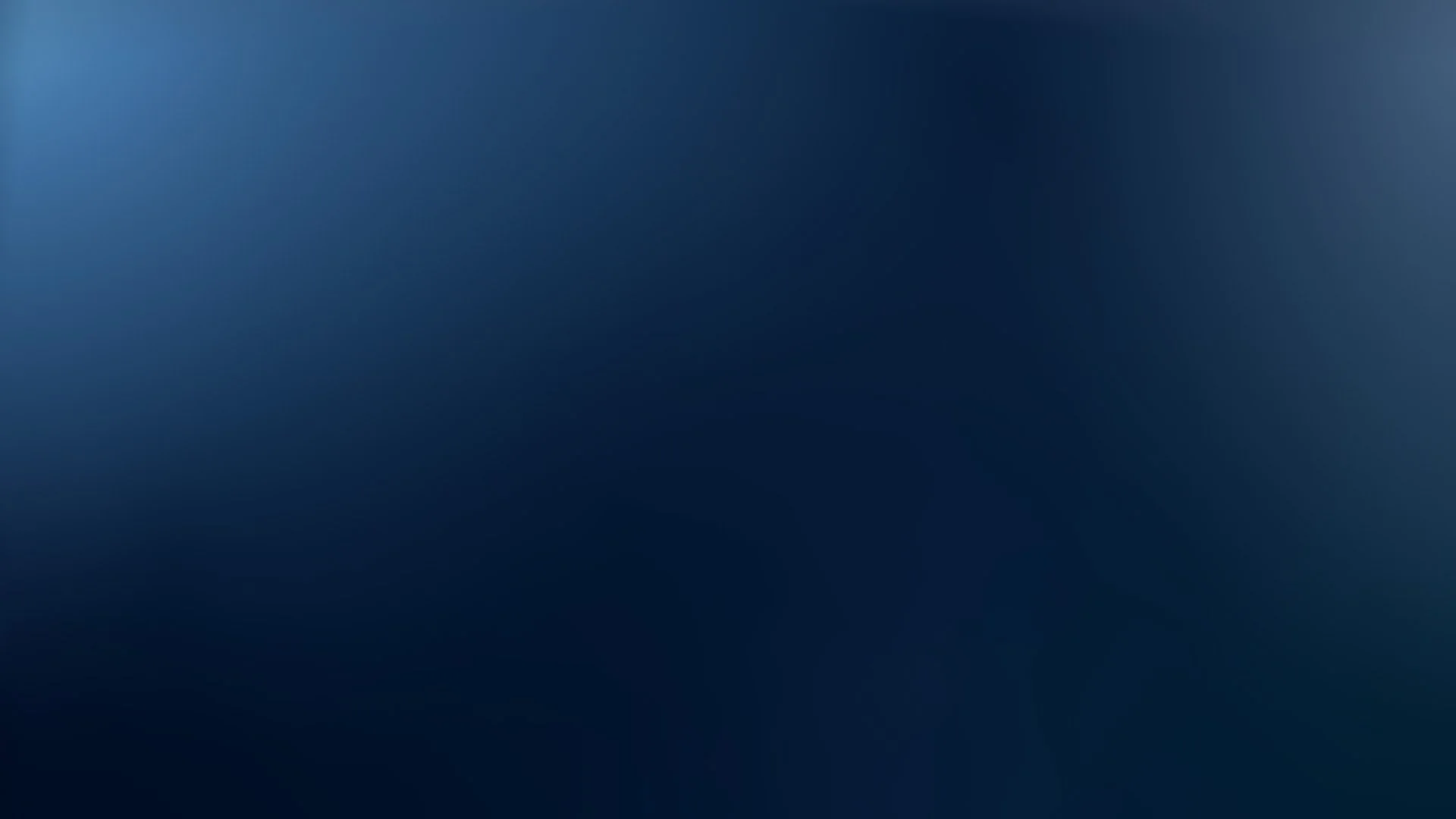 Blurred dark blue background with gradient shades, no discernible objects or details.