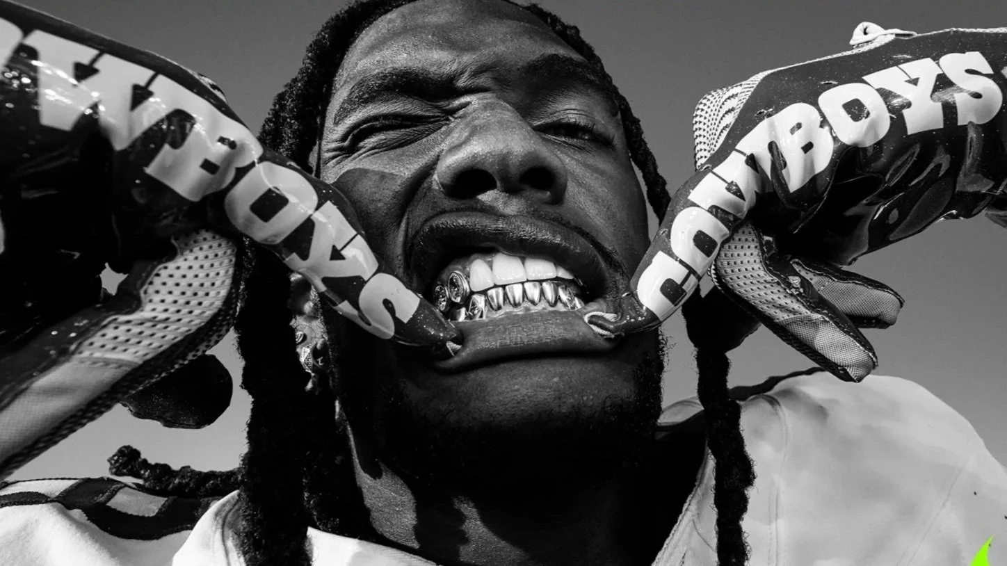 Football player CeeDee Lange showing his diamond mouth grill.