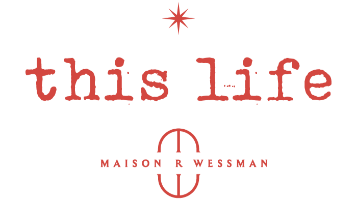 Design featuring the words "this life" in red, with a red star above and a red emblem below containing the text "Maison R Wessman".