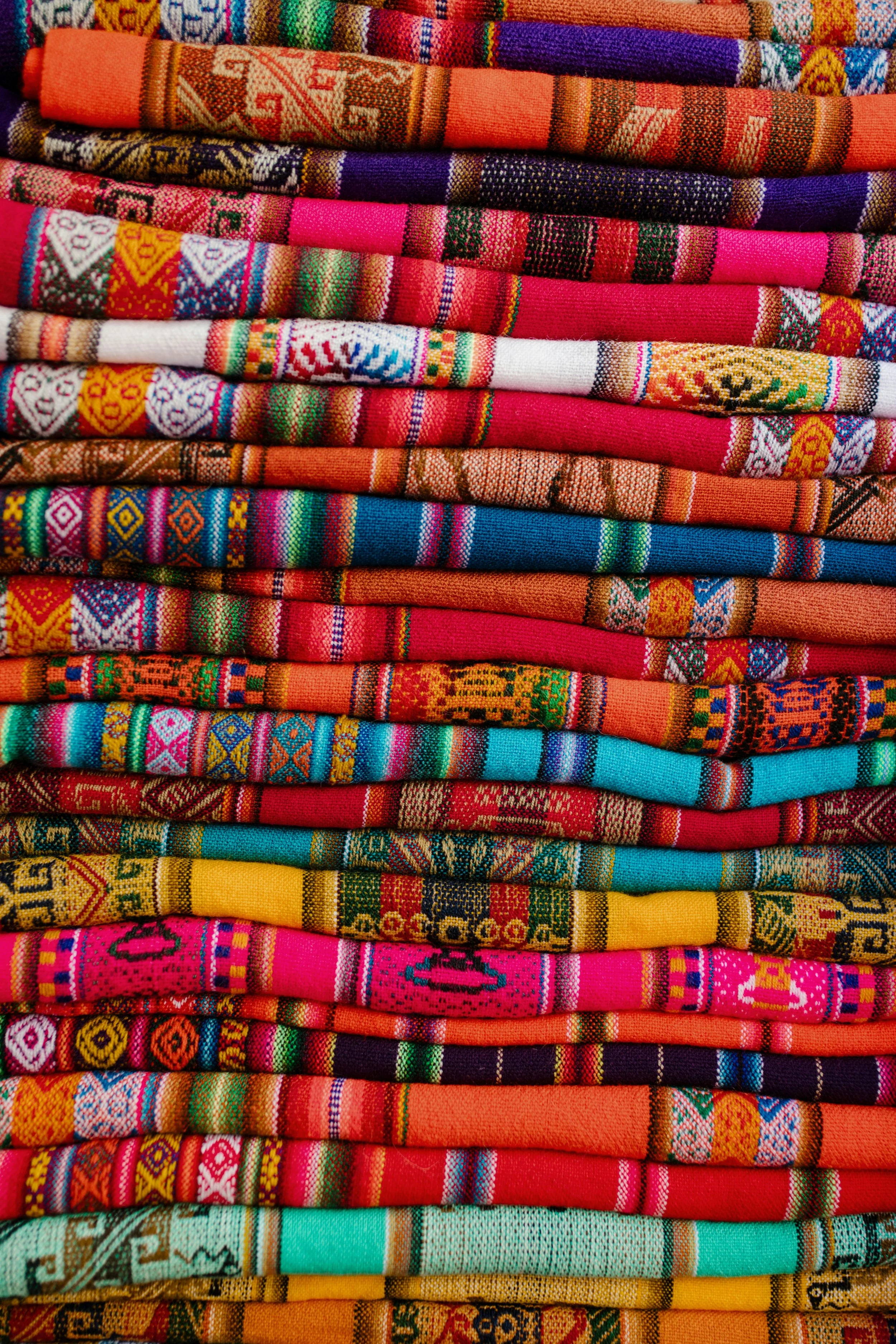 Stack of handwoven textiles illustrating the translation of Indigenous aesthetics into modern design”