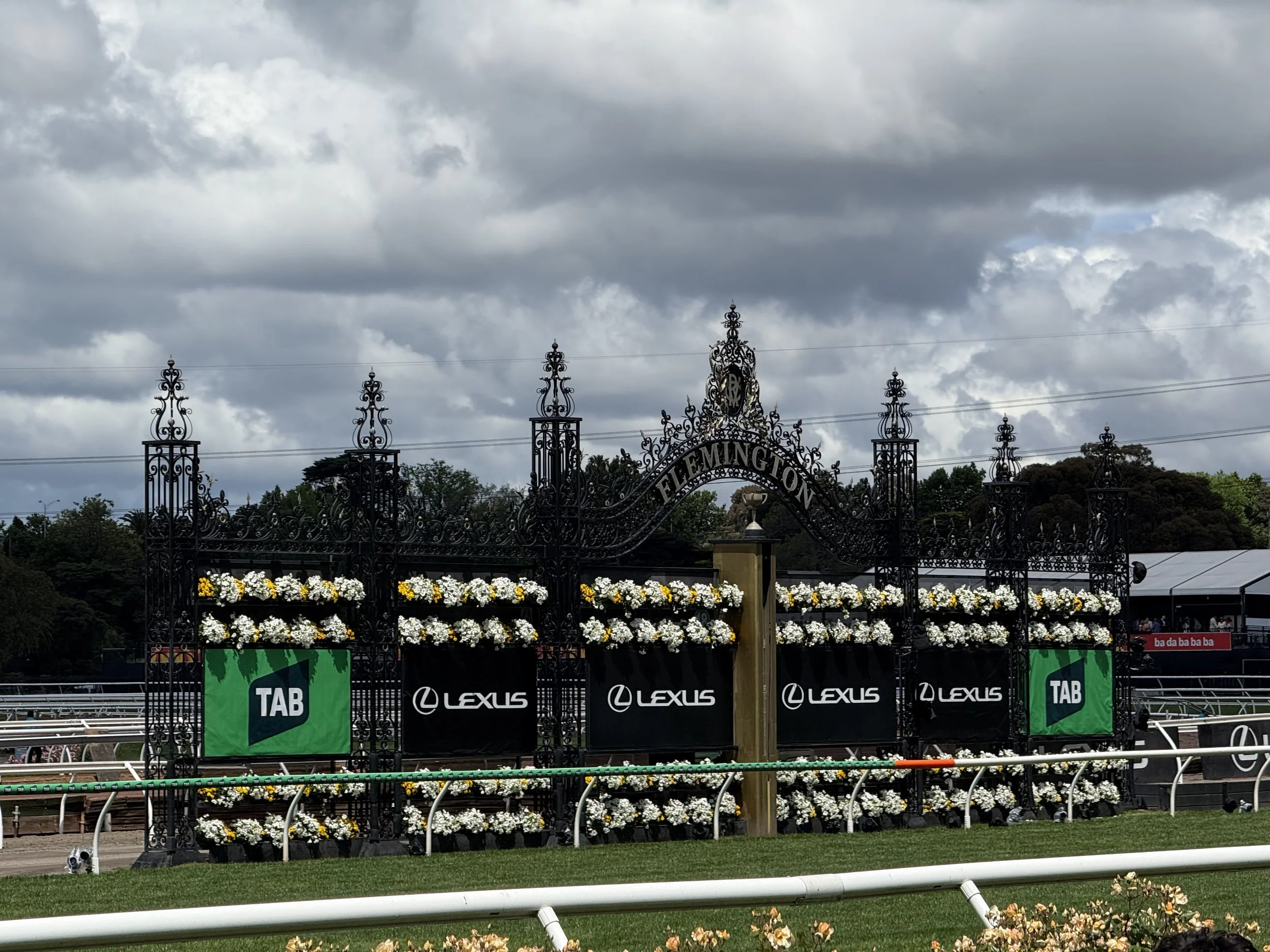  The Flemington finishing post at the 2025 Lexus Melbourne Cup, featuring prominent branding from Lexus and TAB; Two of the event’s key sponsors. 