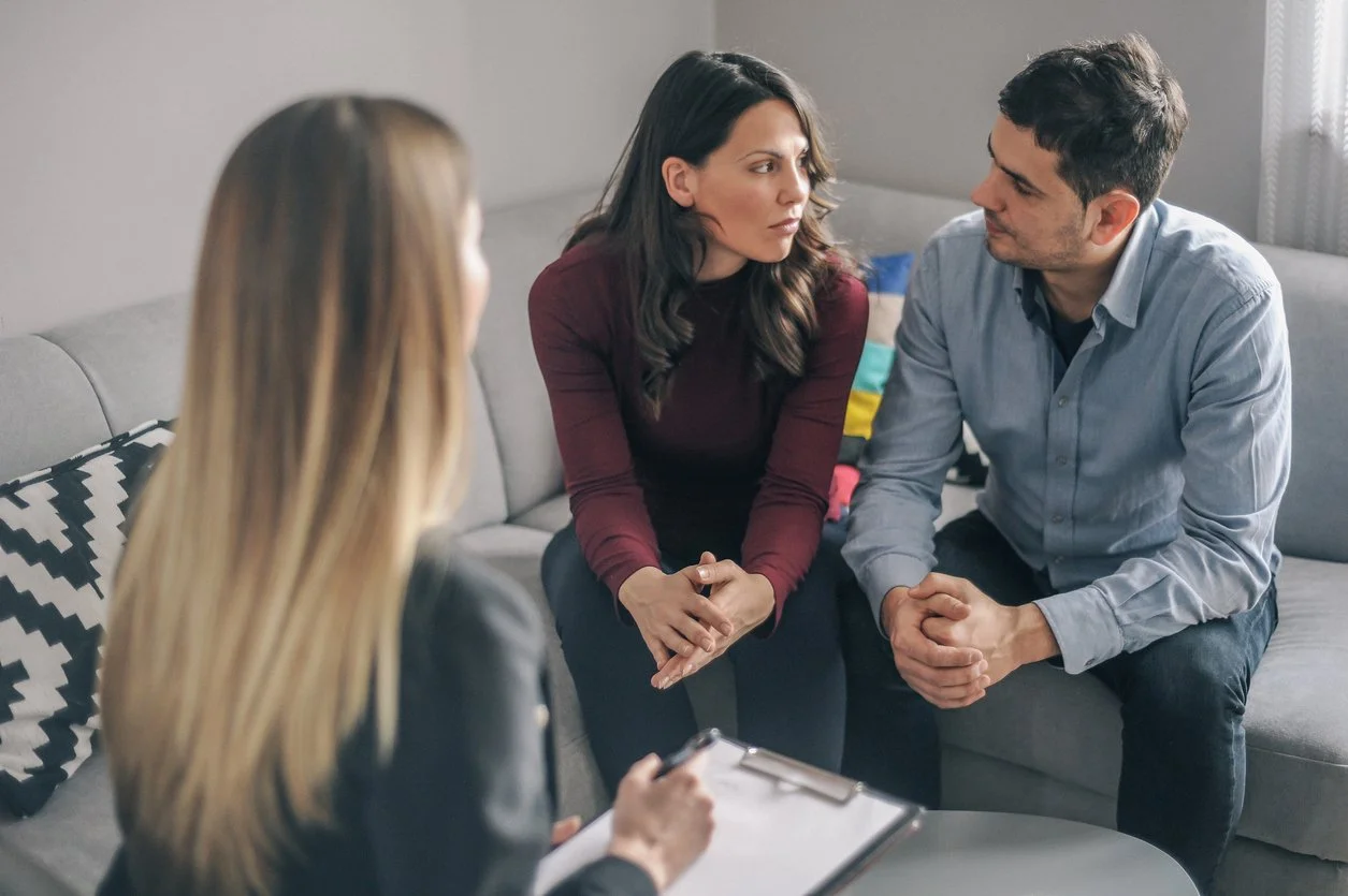A couple speaking with a counsellor