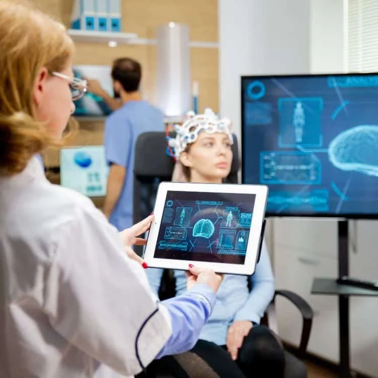 A client participating in QEEG brain mapping with a clinician