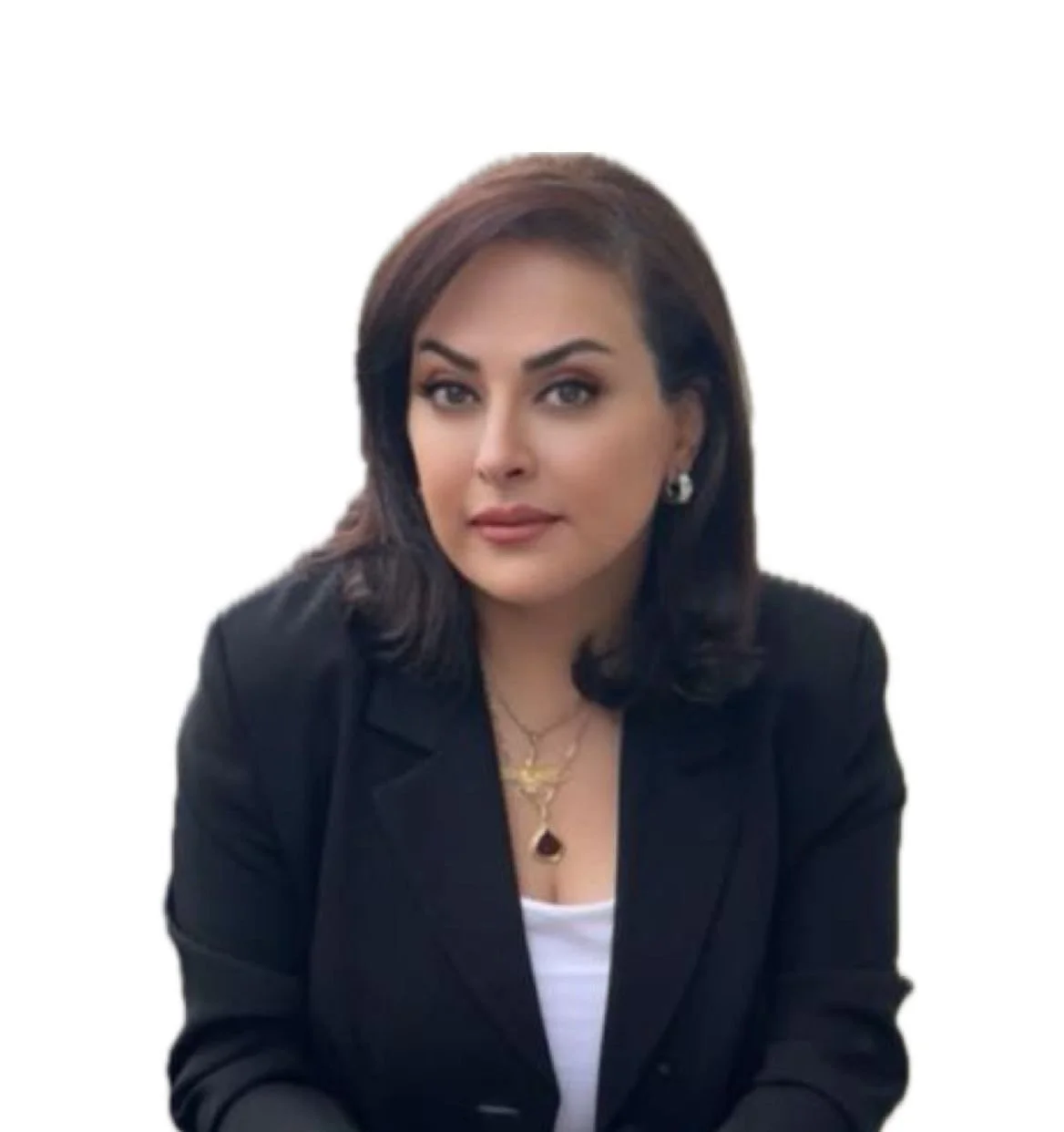 A woman with dark brown hair, wearing a black blazer, white top, and gold jewelry, looking at the camera against a white background.