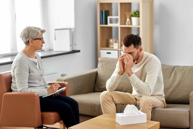 An adult speaking with a therapist