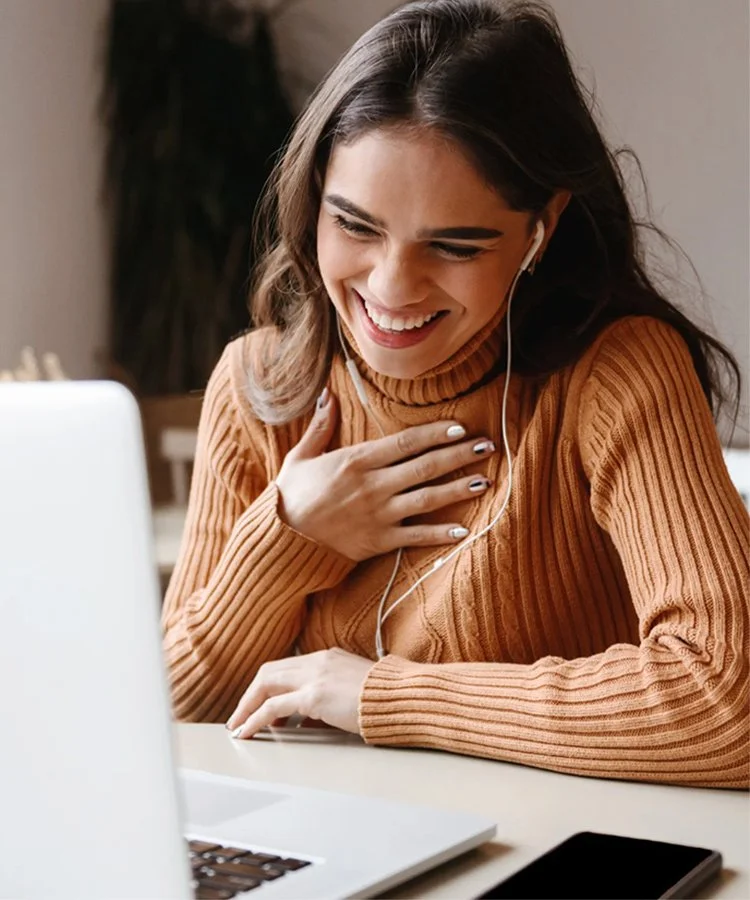A woman laughing after having a christian women's meeting online.