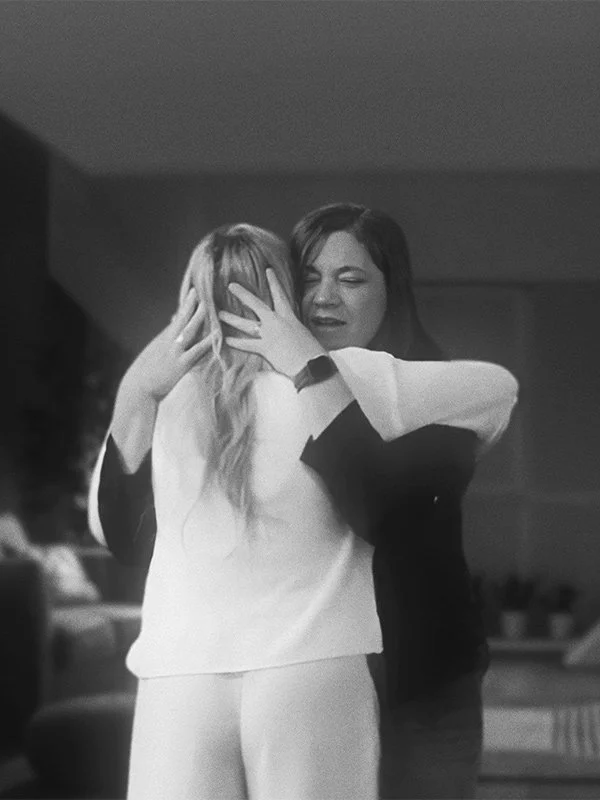 Two women hugging after praying in their women's christian group.