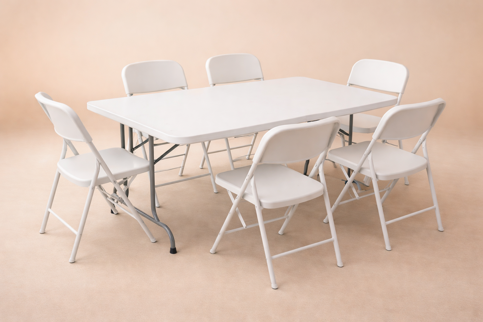 A white rectangular folding table surrounded by six white folding chairs on a beige carpeted floor with a plain beige background.