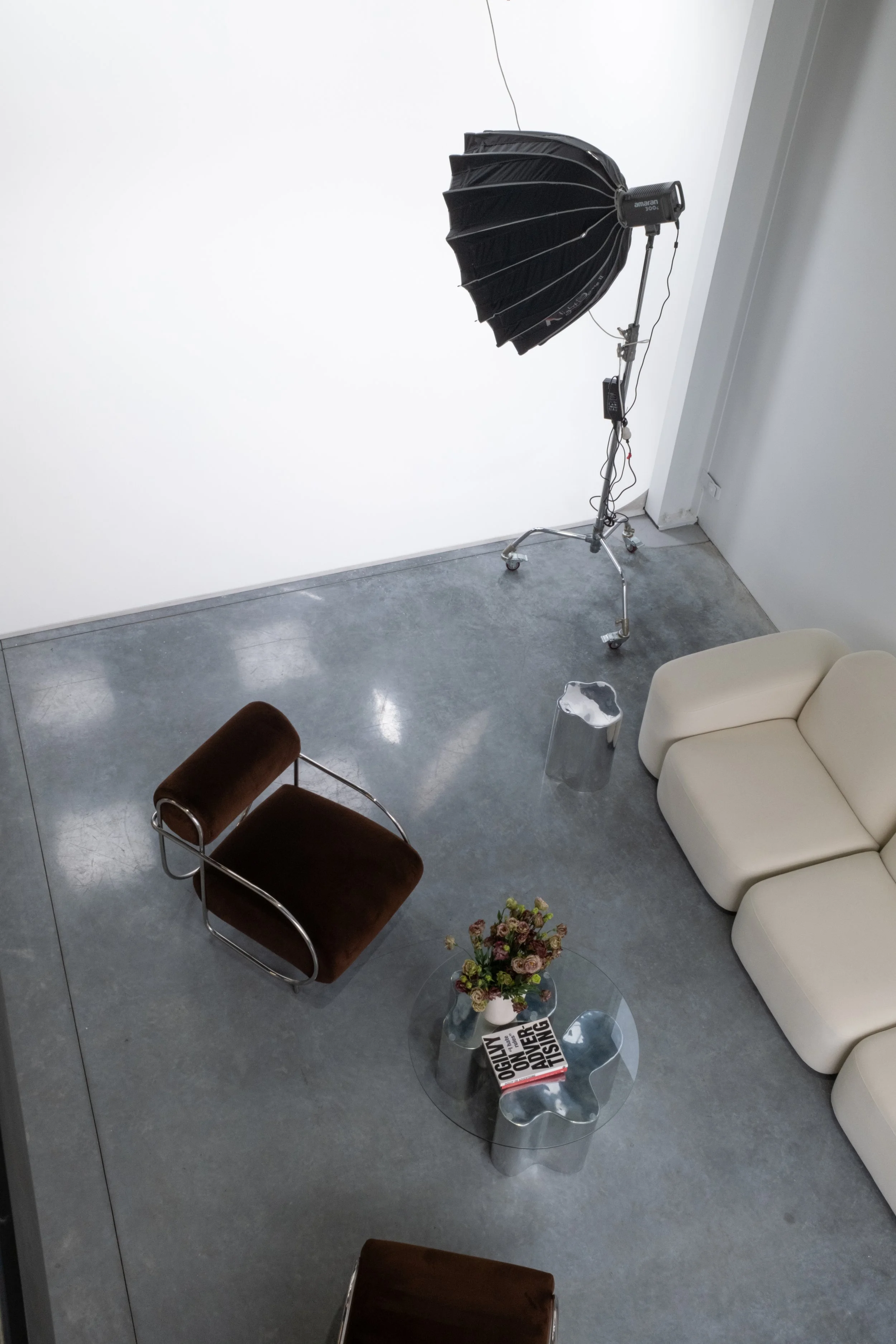 Elevated image of profile studio with brown designer furniture and apture 300x light.