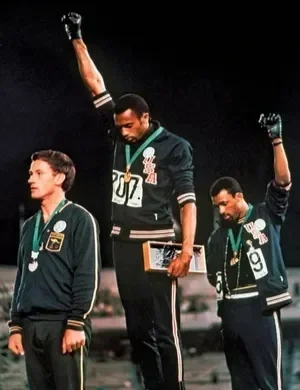 American track medalists Tommie Smith (center) and John Carlos raising black-gloved fists in protest at the 1968 Olympic Games in Mexico City.AP—REX/Shutterstock.com