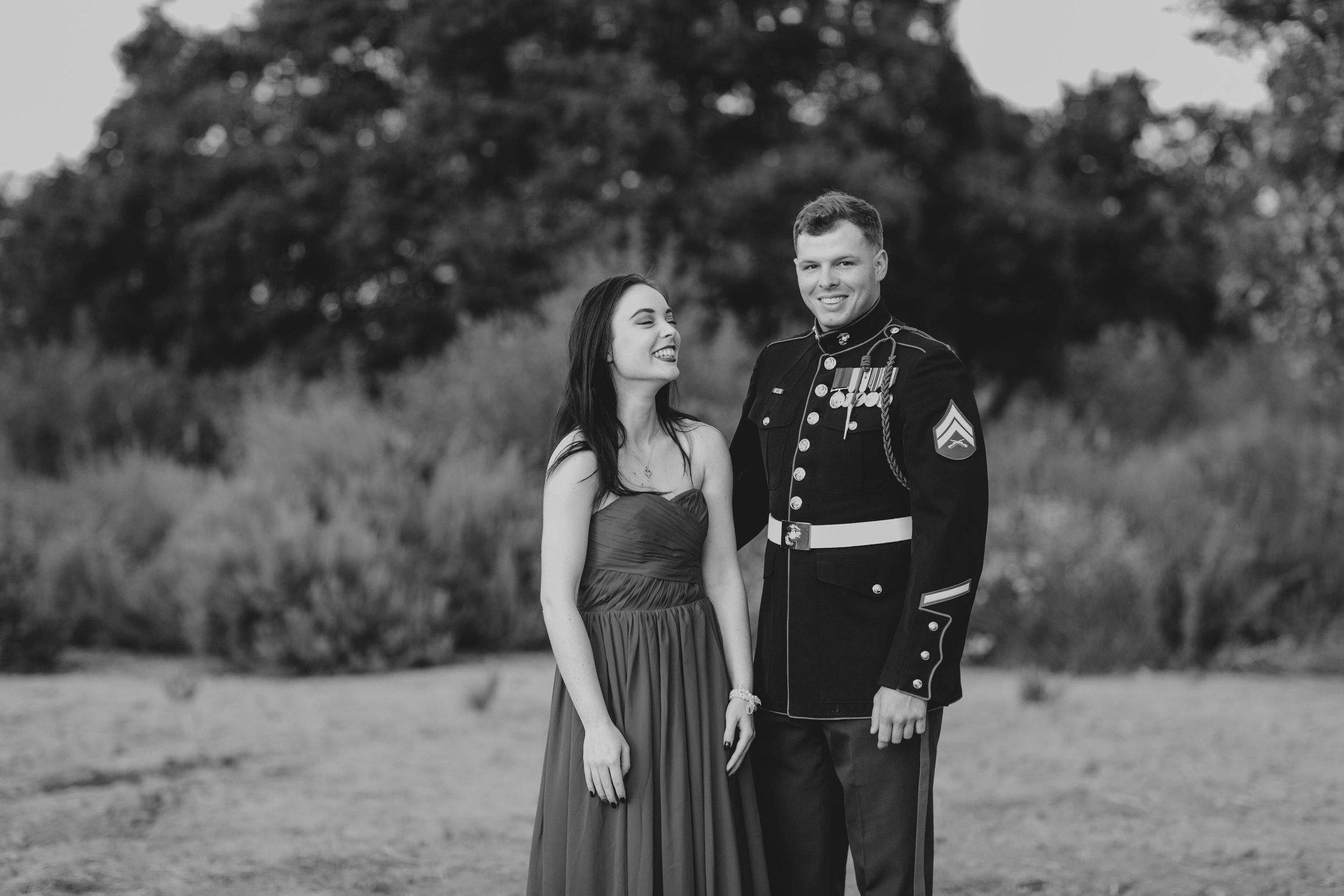 This photo shows the wedding content creator Nicole and Justin standing in military uniform.
