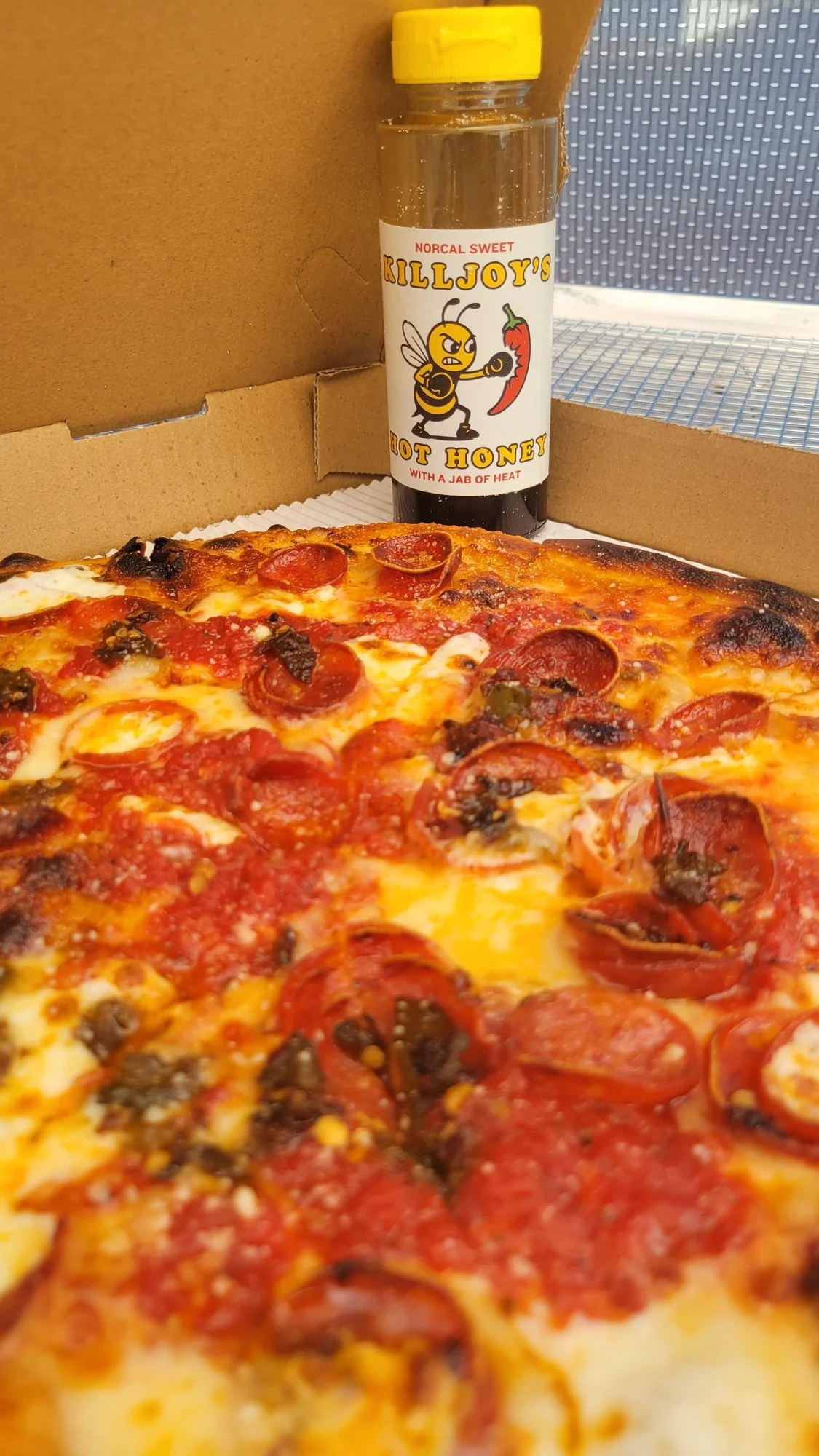 Pepperoni pizza drizzled with Killjoy's Hot Honey
