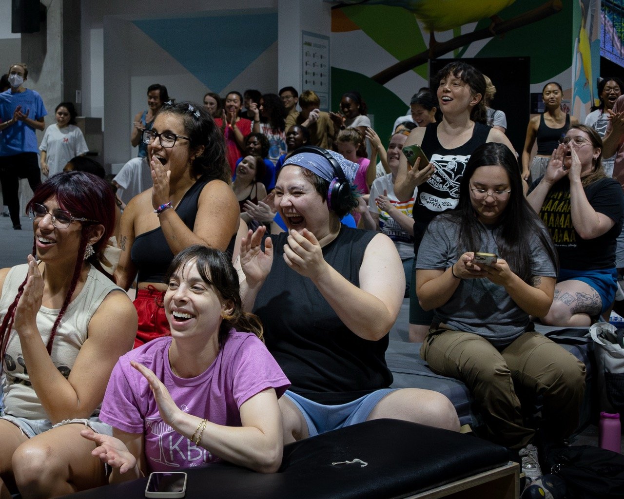 A crowd laughing and clapping during a Pride event in Washington DC