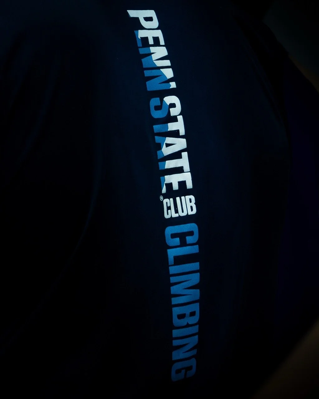 brand photography, alternative "penn state club climbing" on a navy blue jersey
